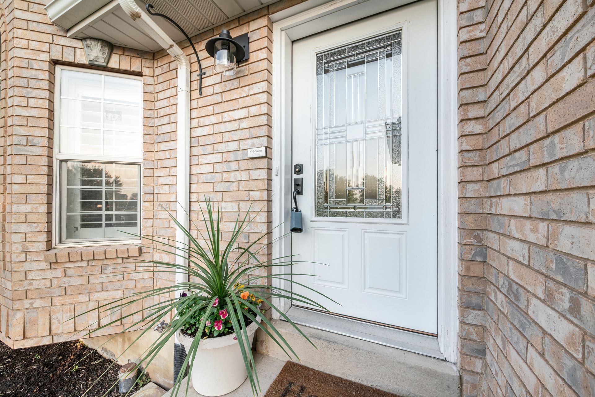 Modern insulated entry door with decorative glass insert, ideal for Colorado homes