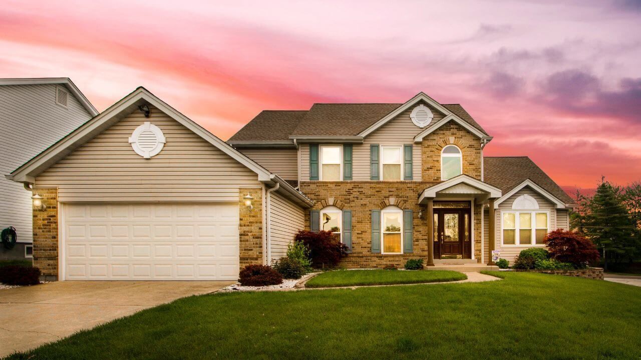 An elegant house set against a breathtaking sunset.