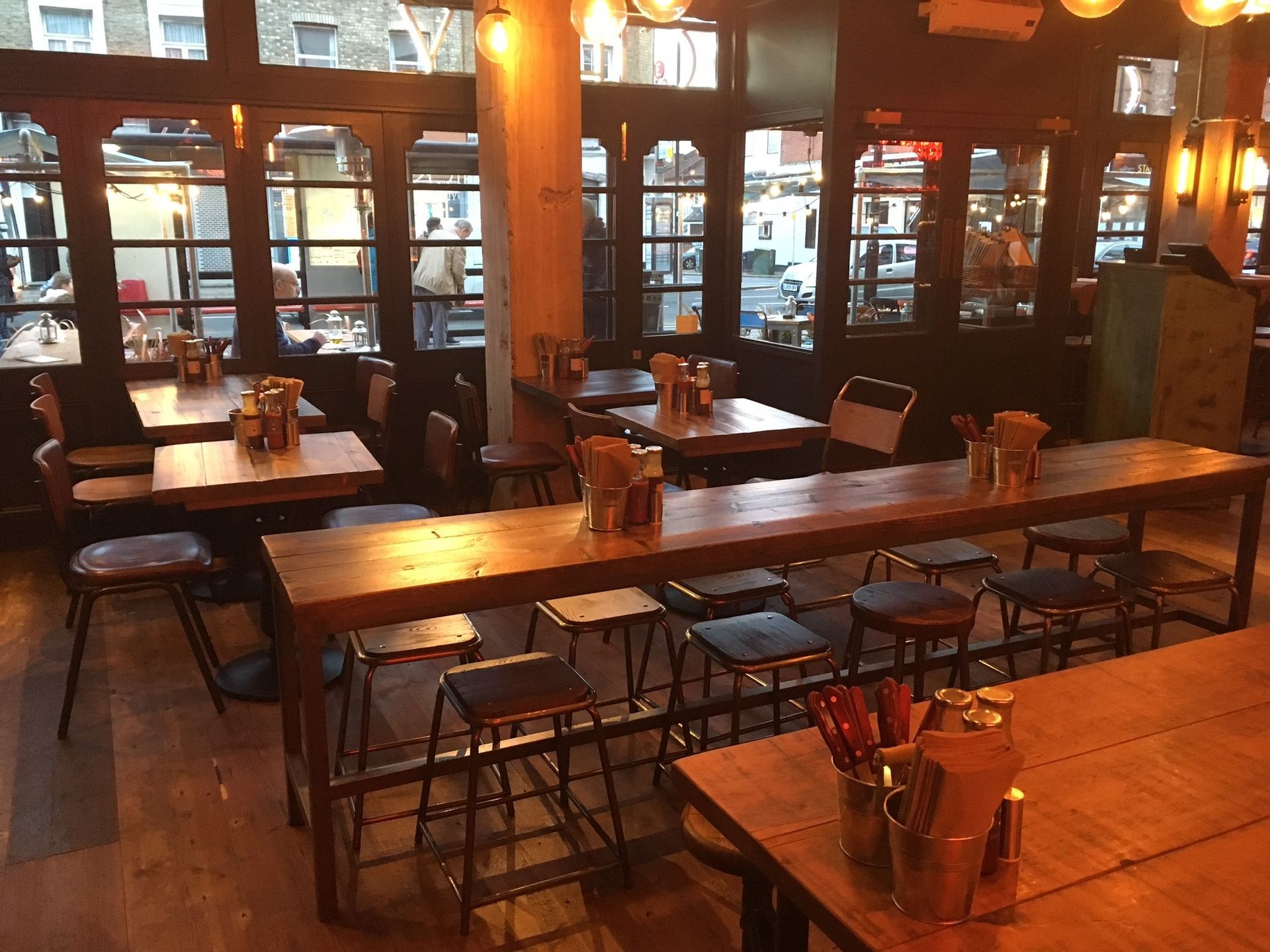 Chicken Society, Finchley, London, view showing industrial furniture and stripped column back to concrete.