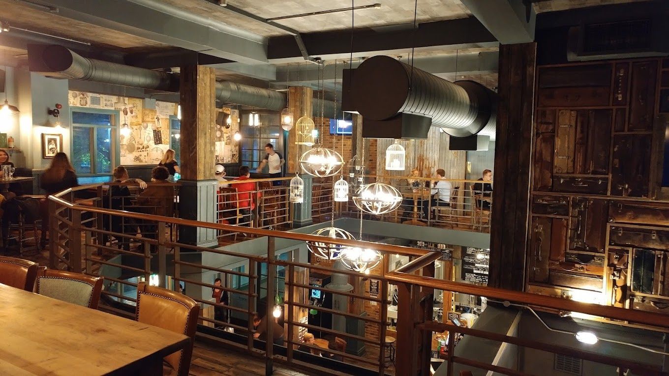 London Road Brew House, Southampton, view across first floor atrium, and showing feature pendant and birdcage lighting.