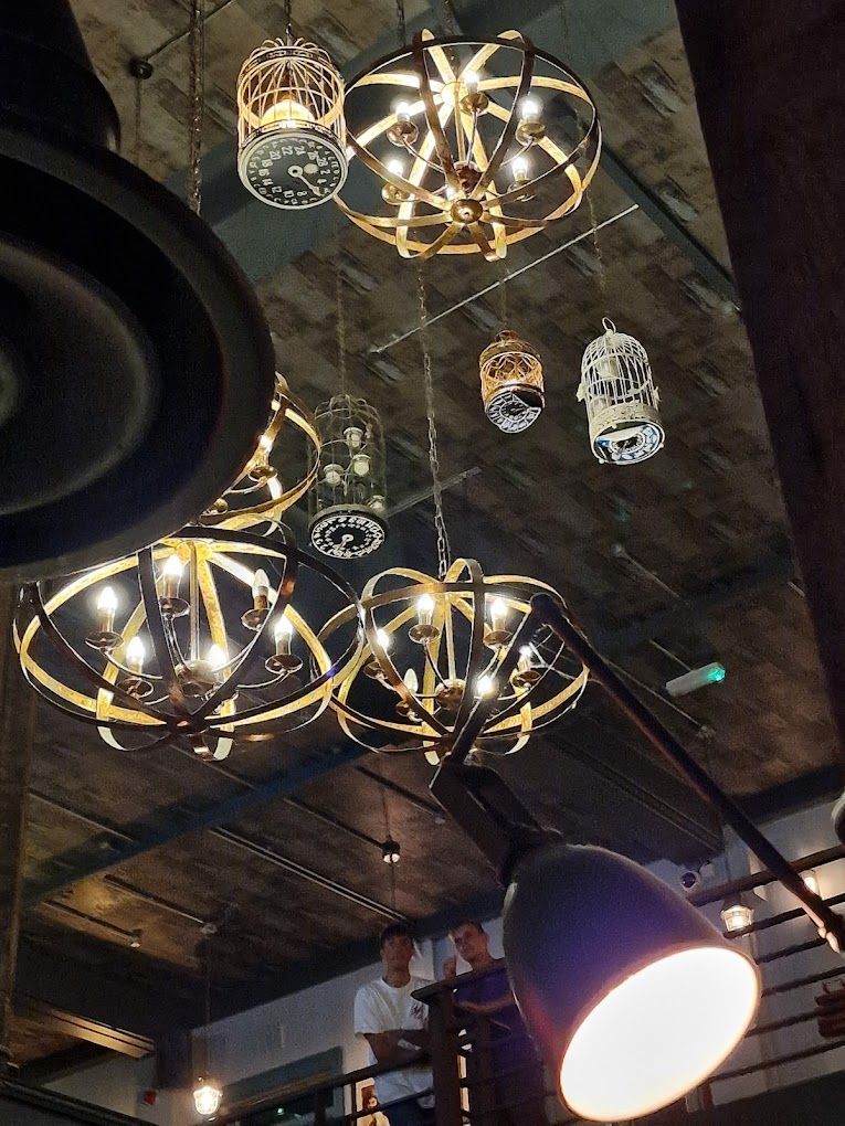 London Road Brew House, Southampton, looking up at industrial feature pendant lights and birdcage pendant lights.
