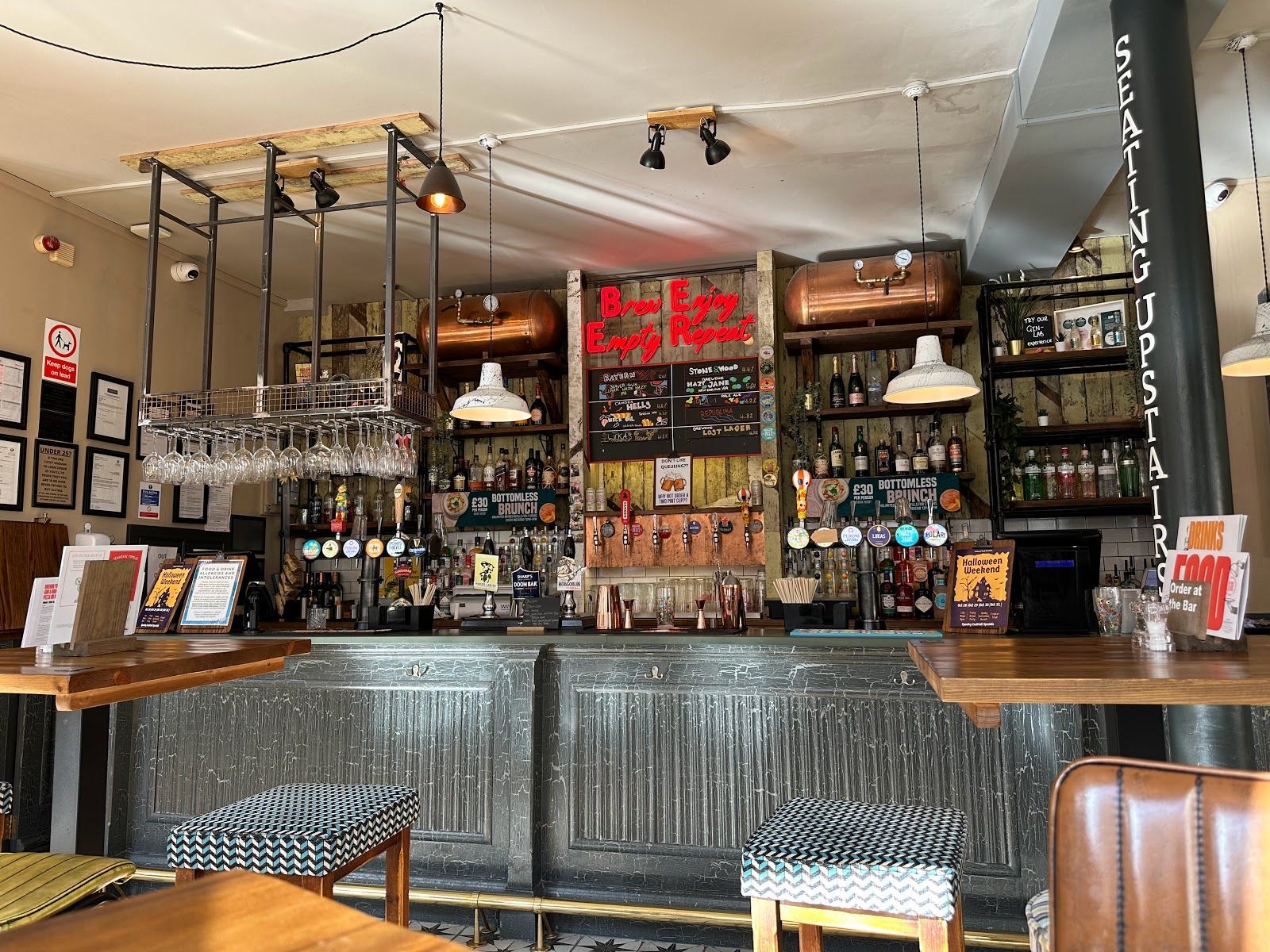 Prince of Teck, Earls Court, London, view towards main ground floor bar counter, distressed painted bar front and industrial style backfitting.