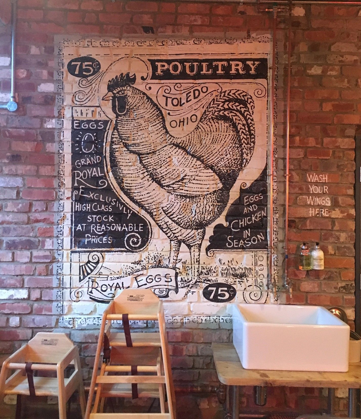 Chicken Society, Finchley, London, feature chicken mural painted to reclaimed brickwork.