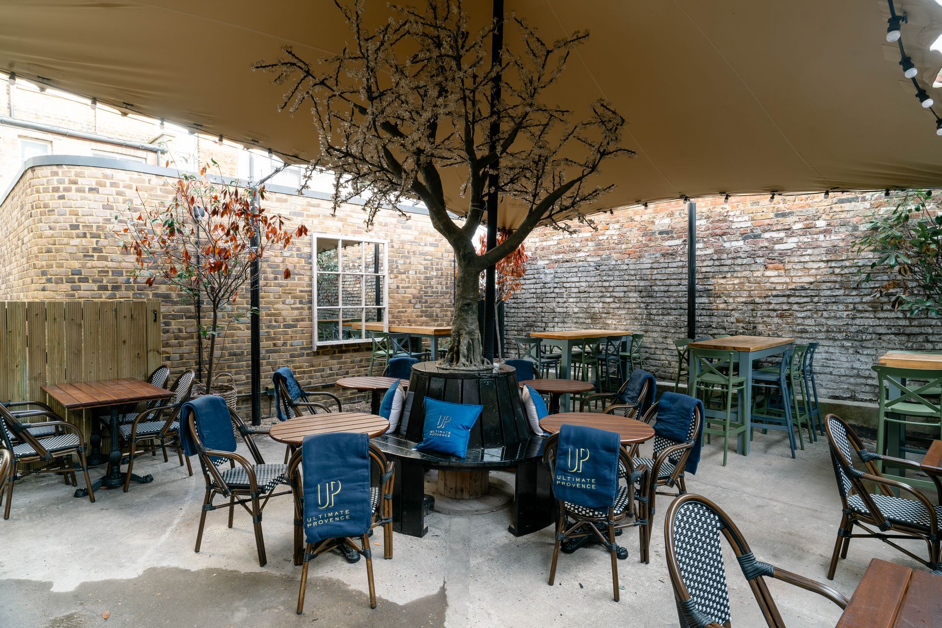 Lillie Langtry, Fulham, rear external terrace garden area, with central tree feature and awning to cover seating area.