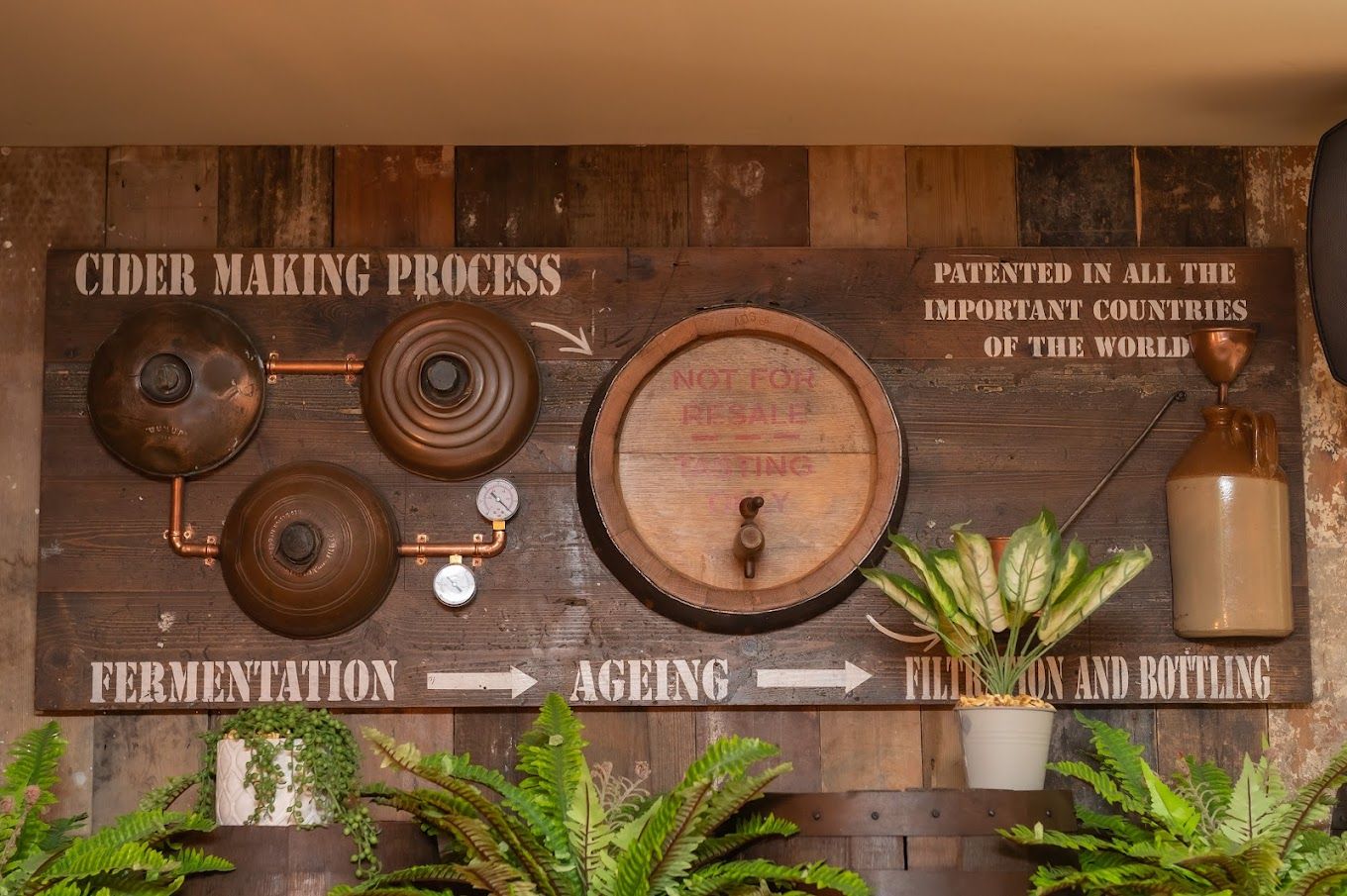 Bath Cider House, feature cider making process painted onto reclaimed timber wall.