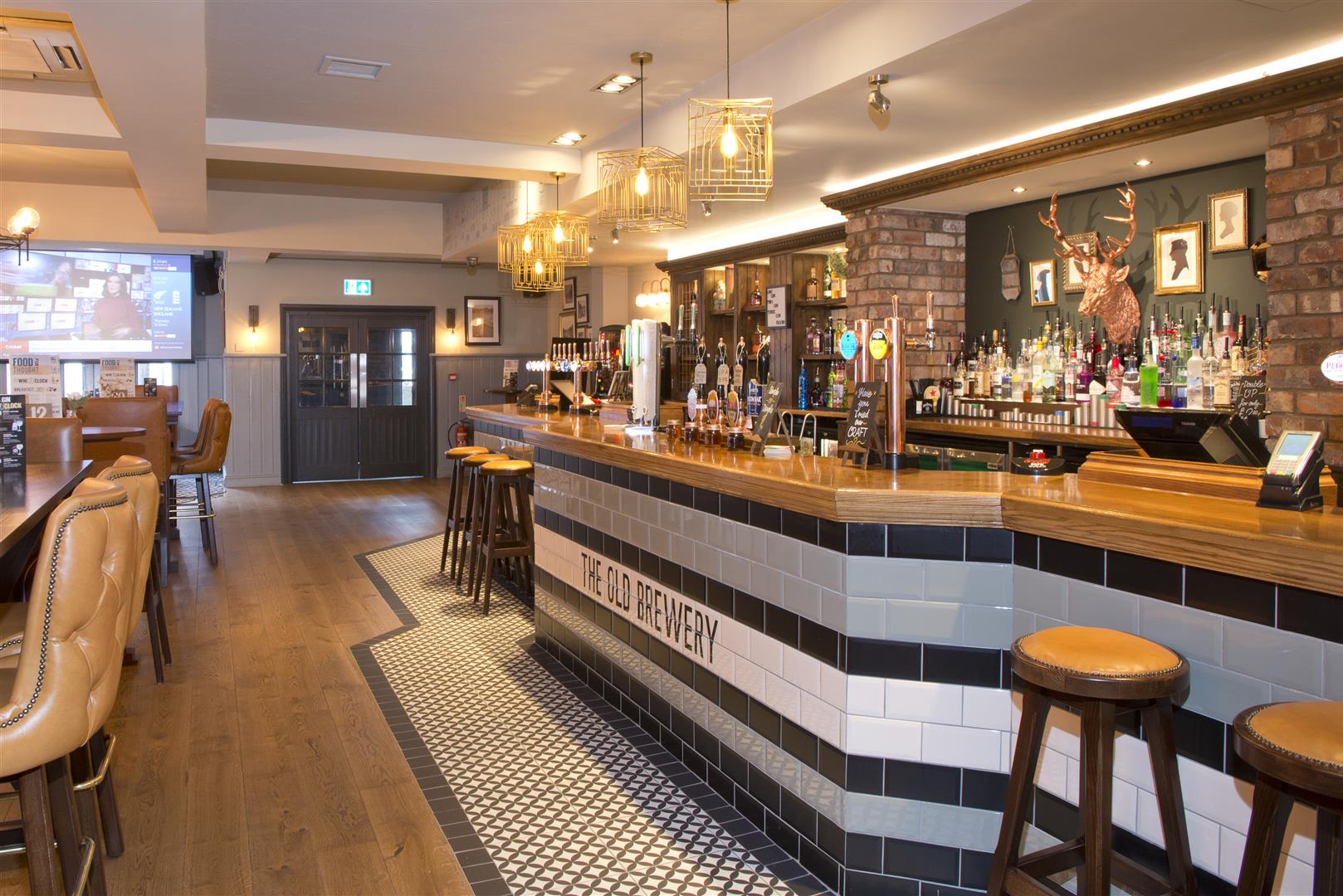 The Old Brewery, Marlow, tiled bar counter front and tiled bar walk, with decorative pendant lighting over bar.
