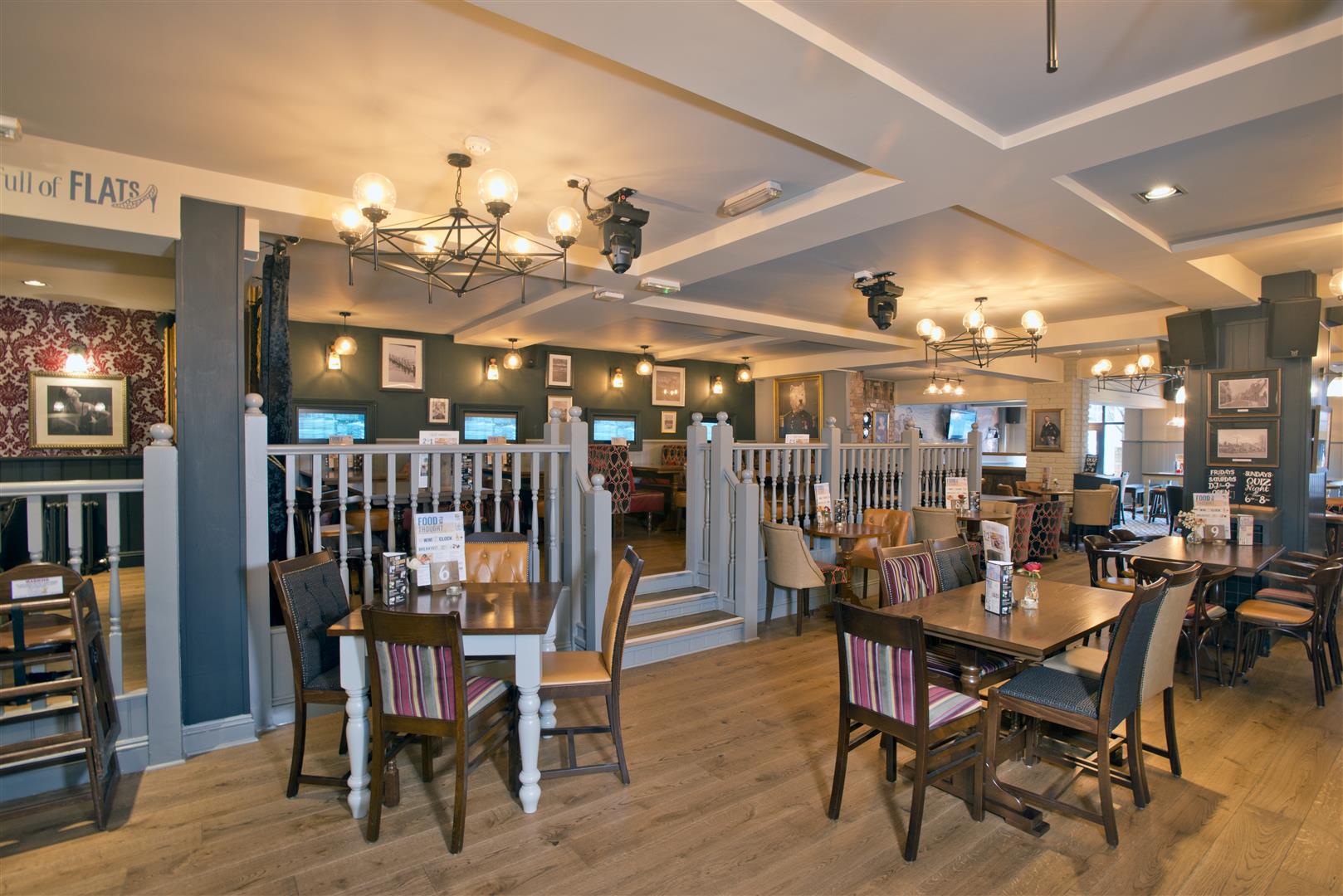 The Old Brewery, Marlow, central dining /seating area, with decorative chandeliers overhead.