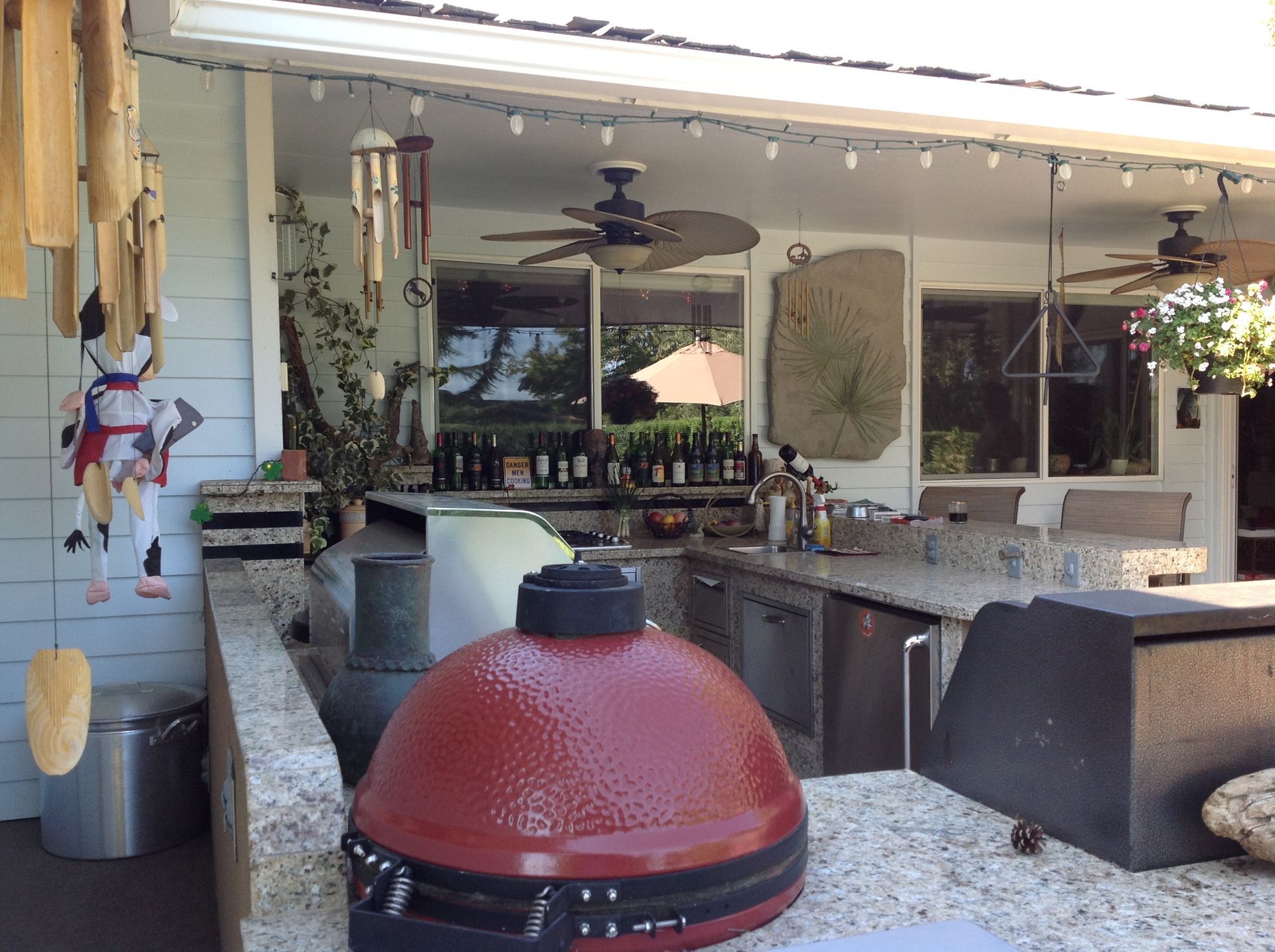 A red grill is sitting on a counter in a kitchen