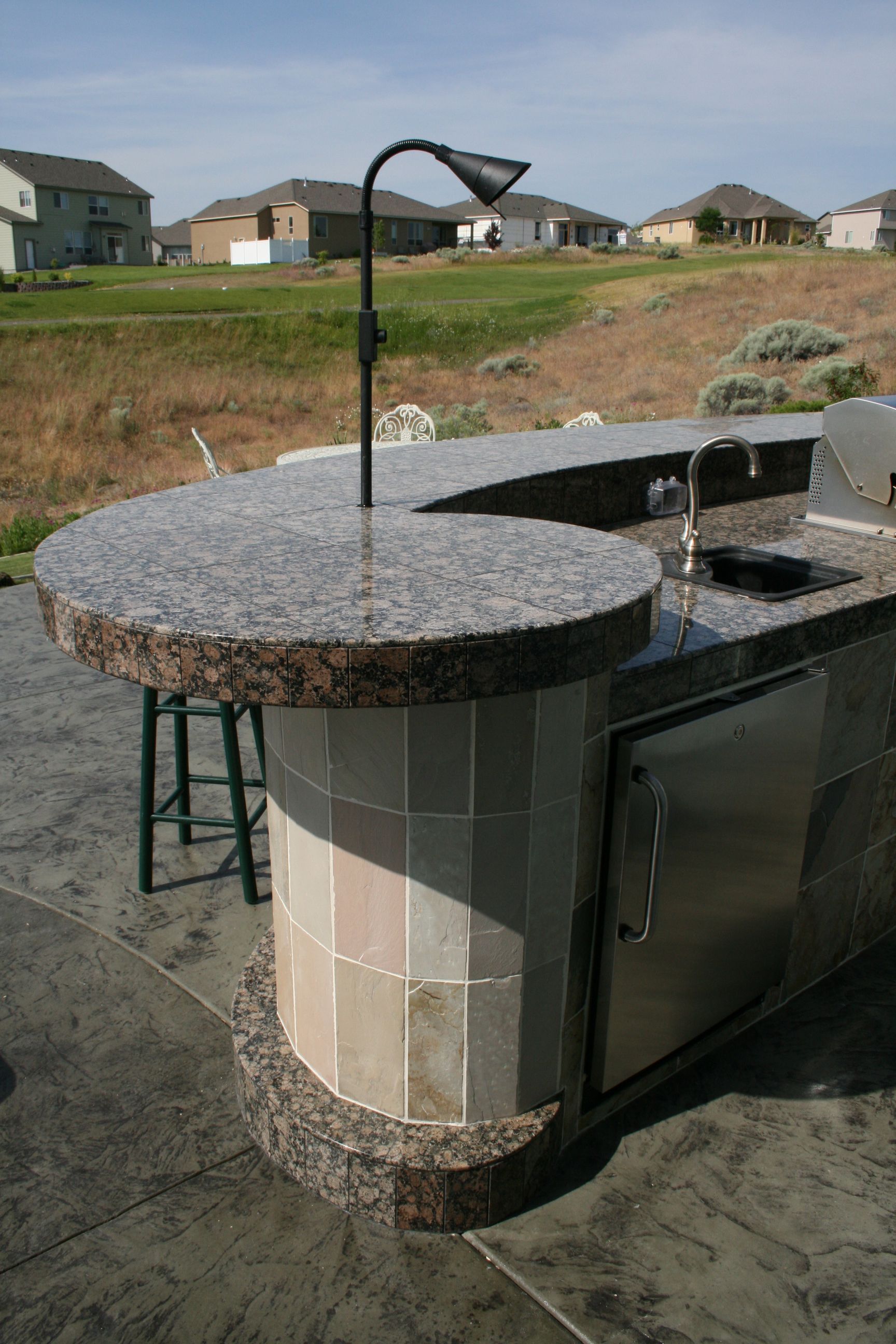 A kitchen with a granite counter top and a sink.
