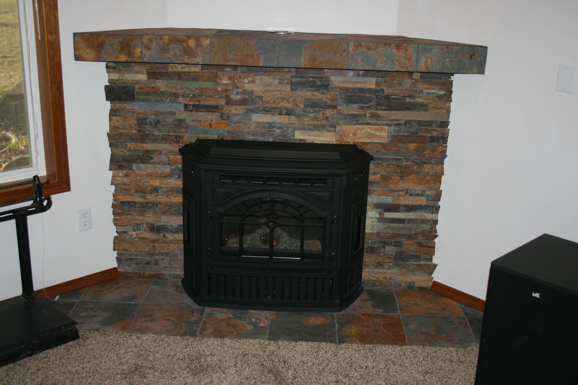 There is a fireplace in the corner of the room.