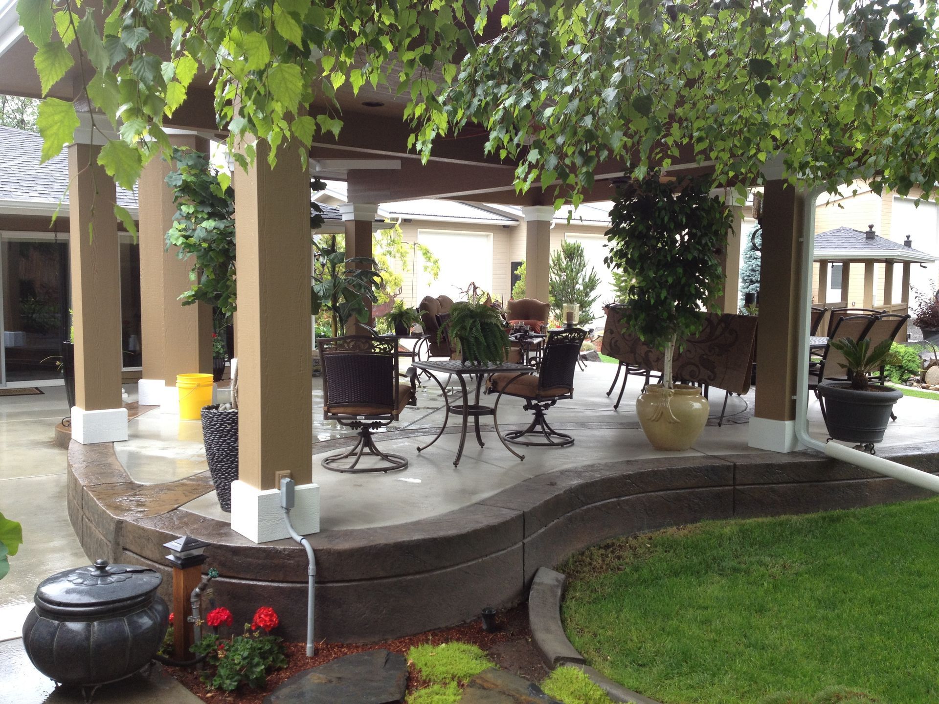 A patio area with tables and chairs under a pergola