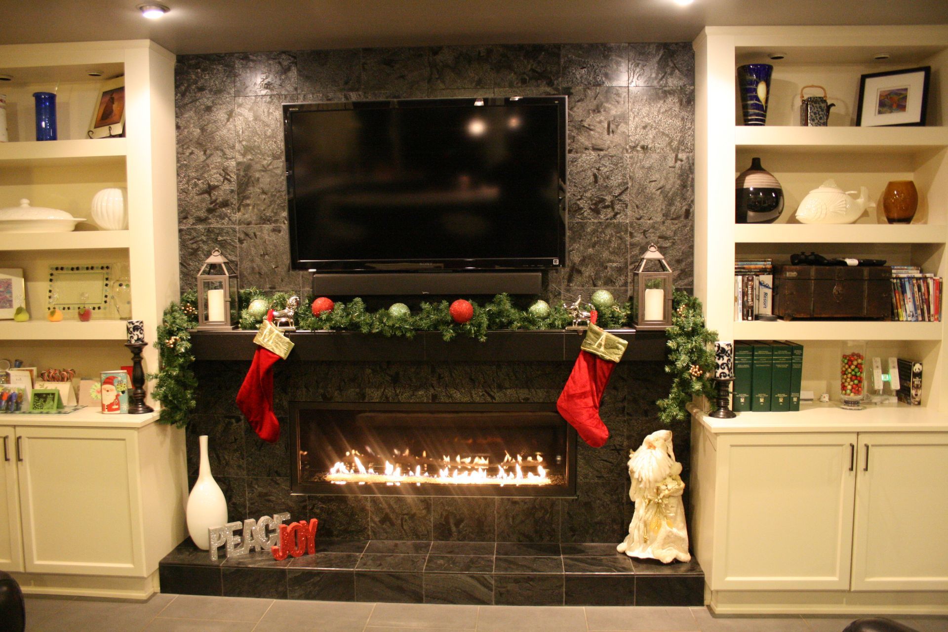 A fireplace with stockings on it and a sign that says peace on it