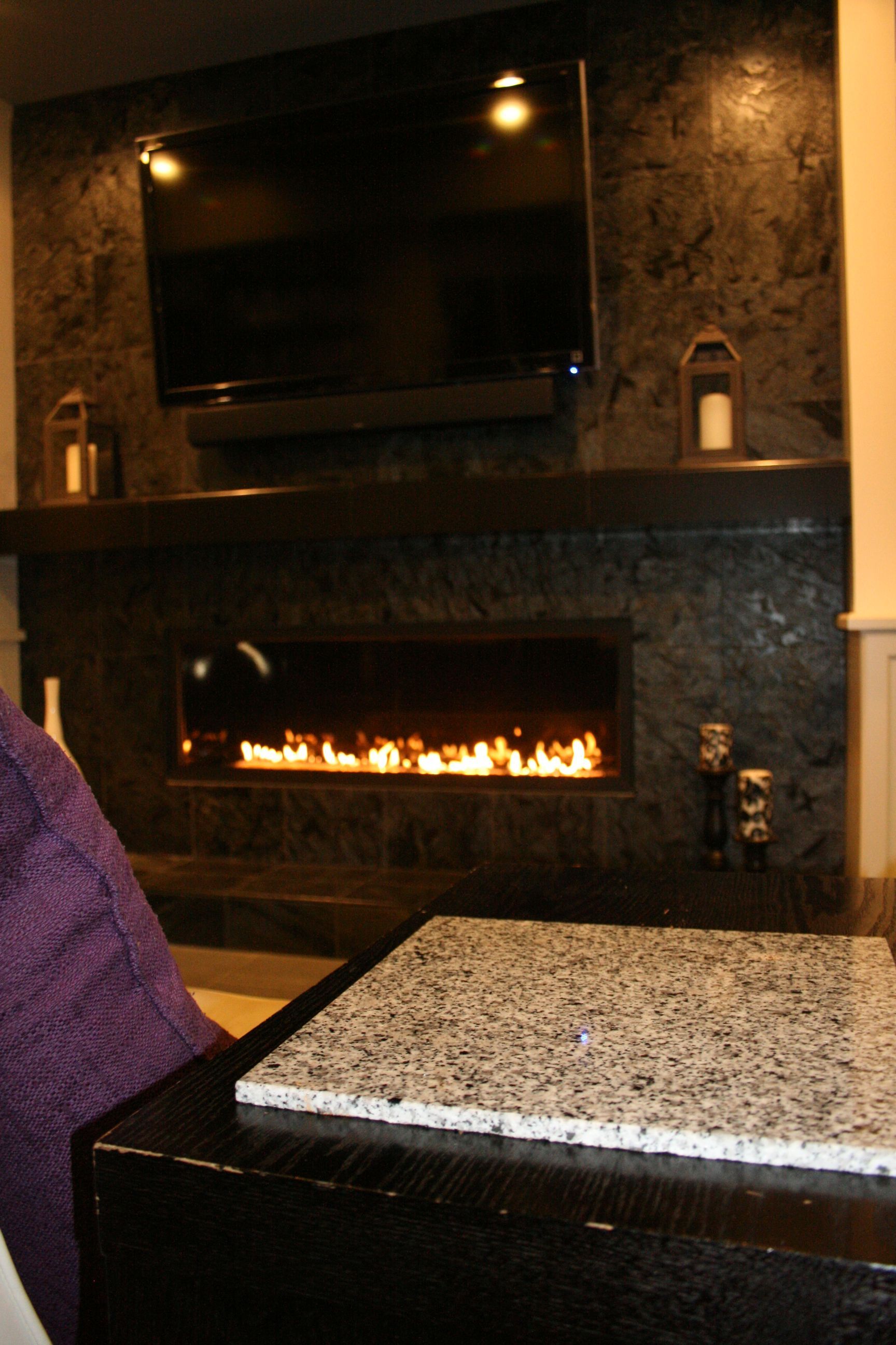 A fireplace with a flat screen tv above it