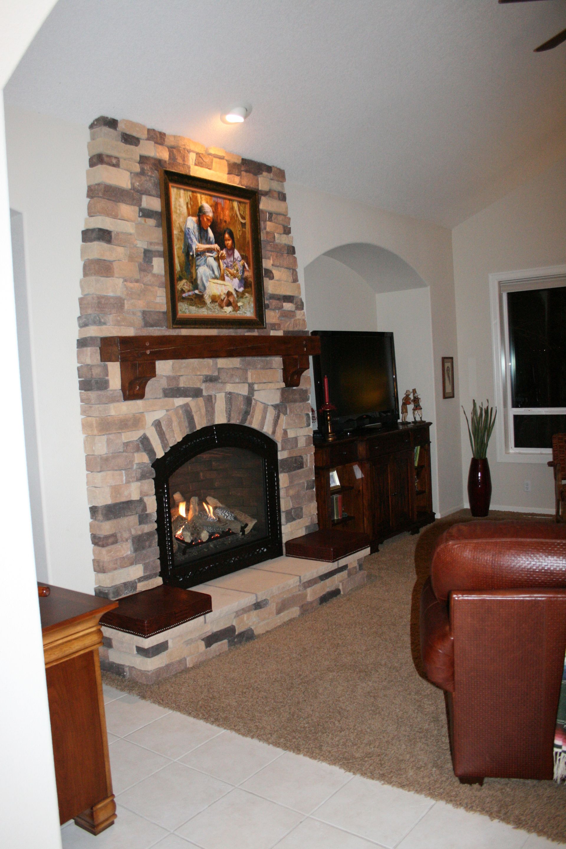 A living room with a fireplace and a television