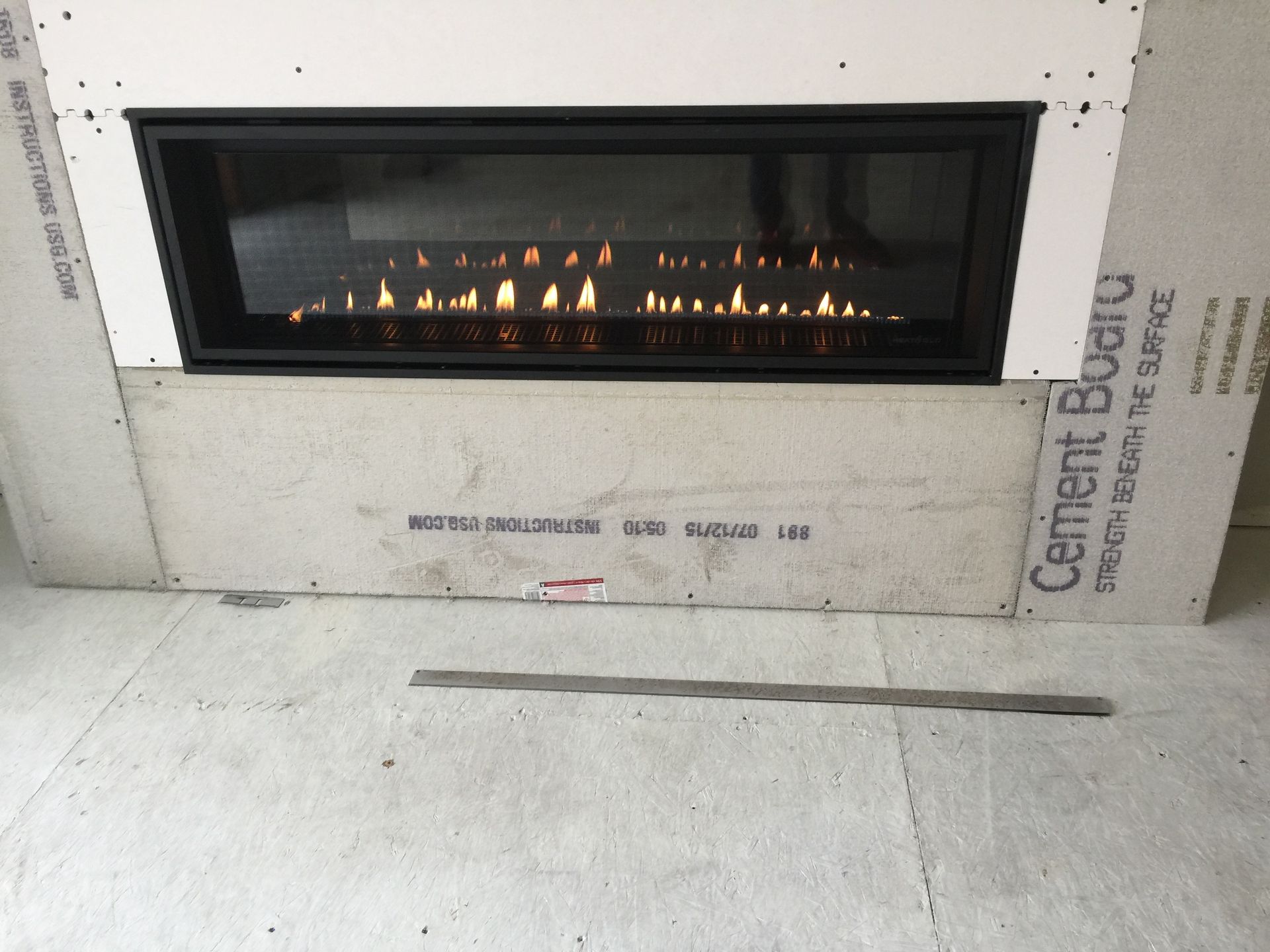 A fireplace with a cement board behind it