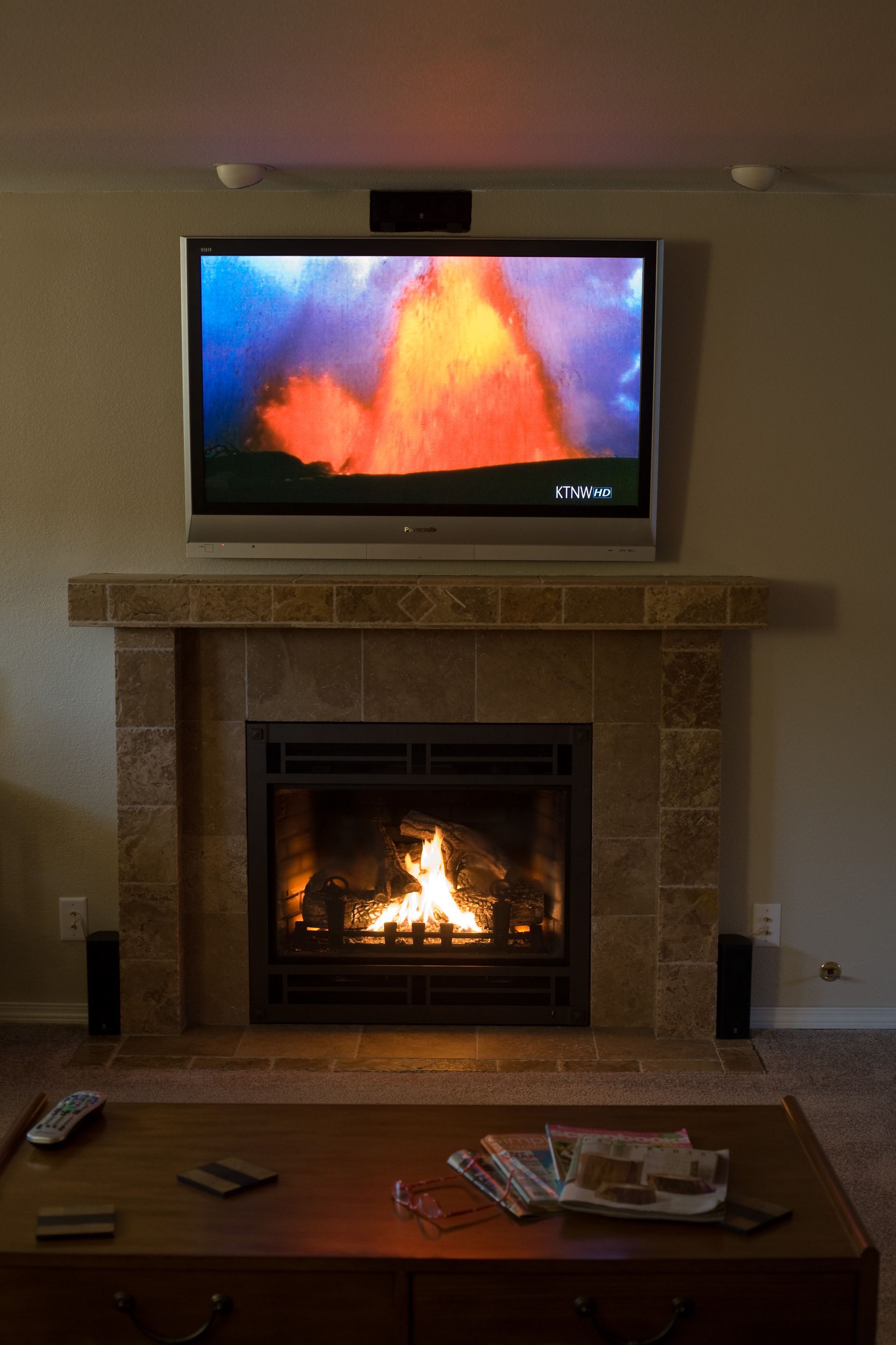A living room with a fireplace and a flat screen tv