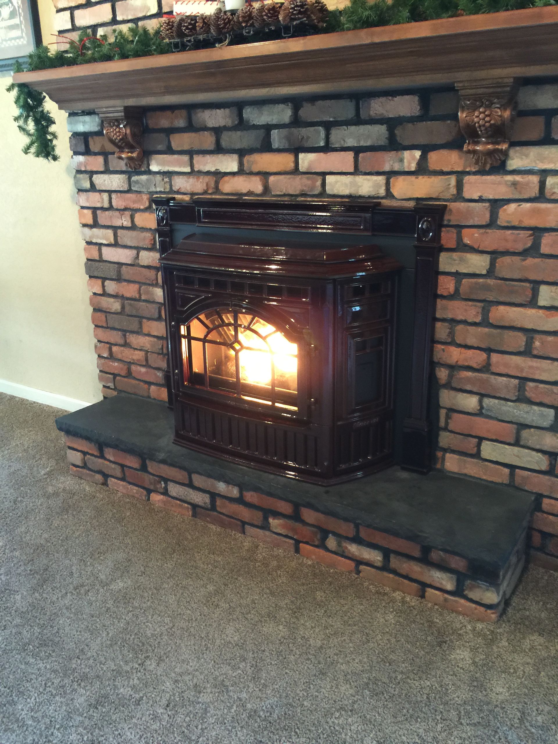 A brick fireplace with a wood stove in it