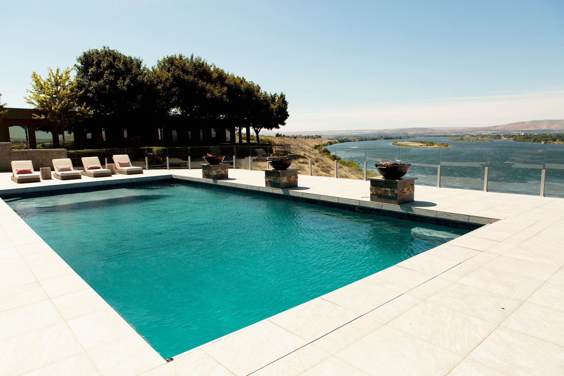 A large swimming pool with a view of a lake