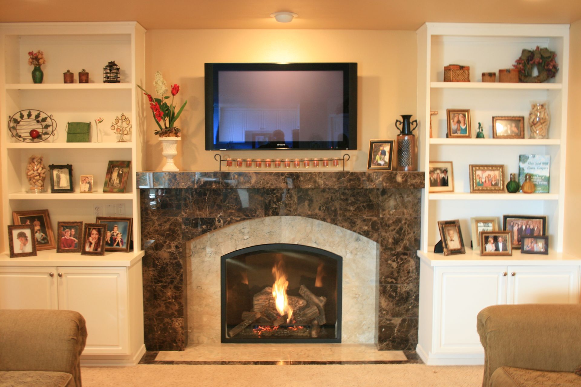 A living room with a fireplace and a flat screen tv
