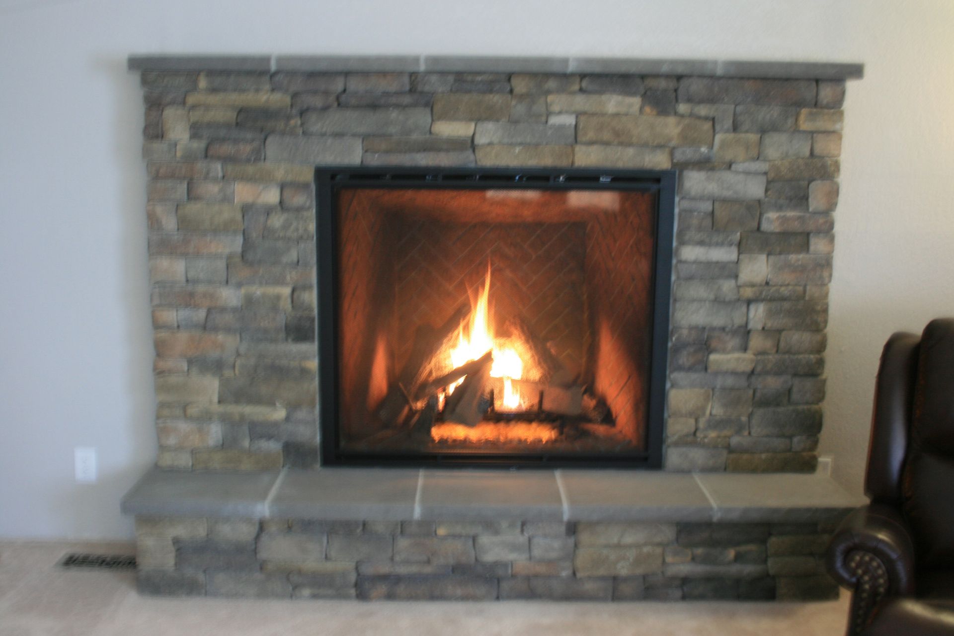 A living room with a fireplace and a chair