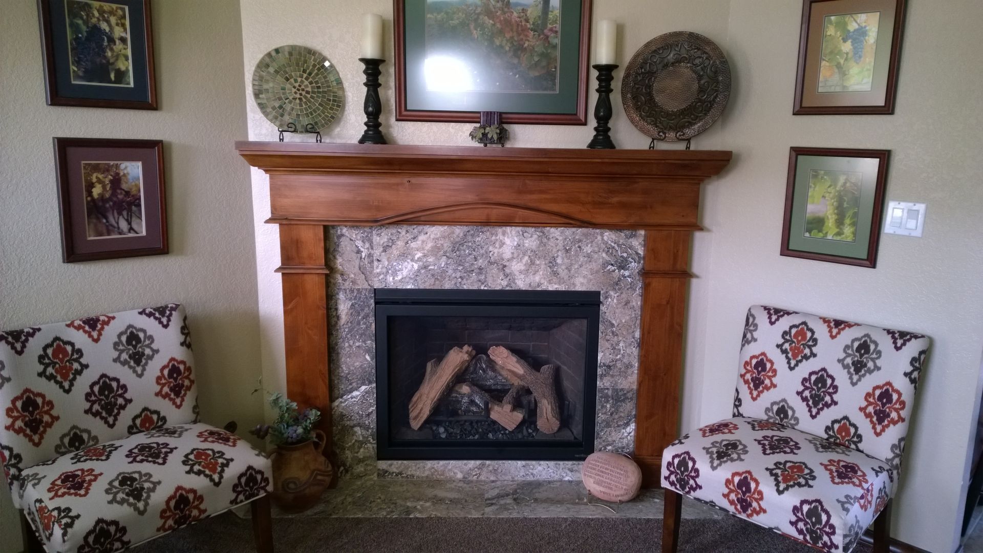 A living room with two chairs and a fireplace