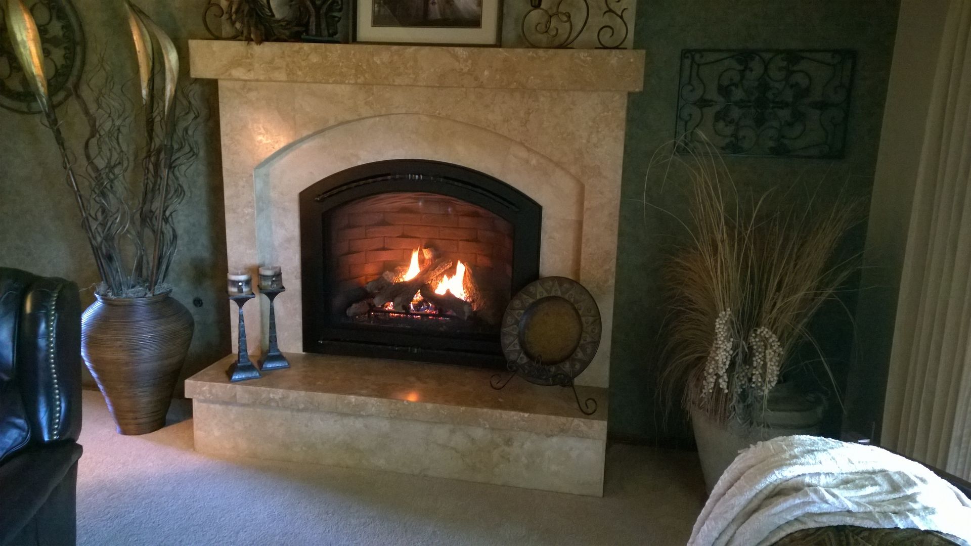 A living room with a fireplace and a chair