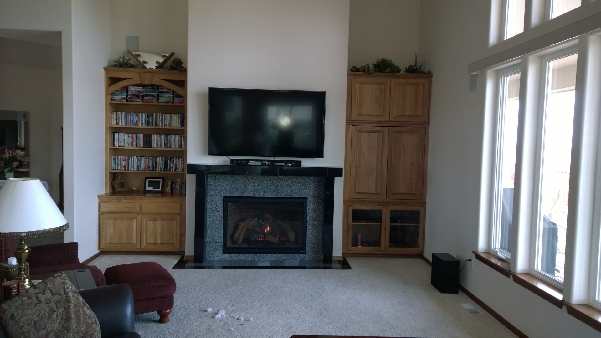 A living room with a fireplace and a flat screen tv