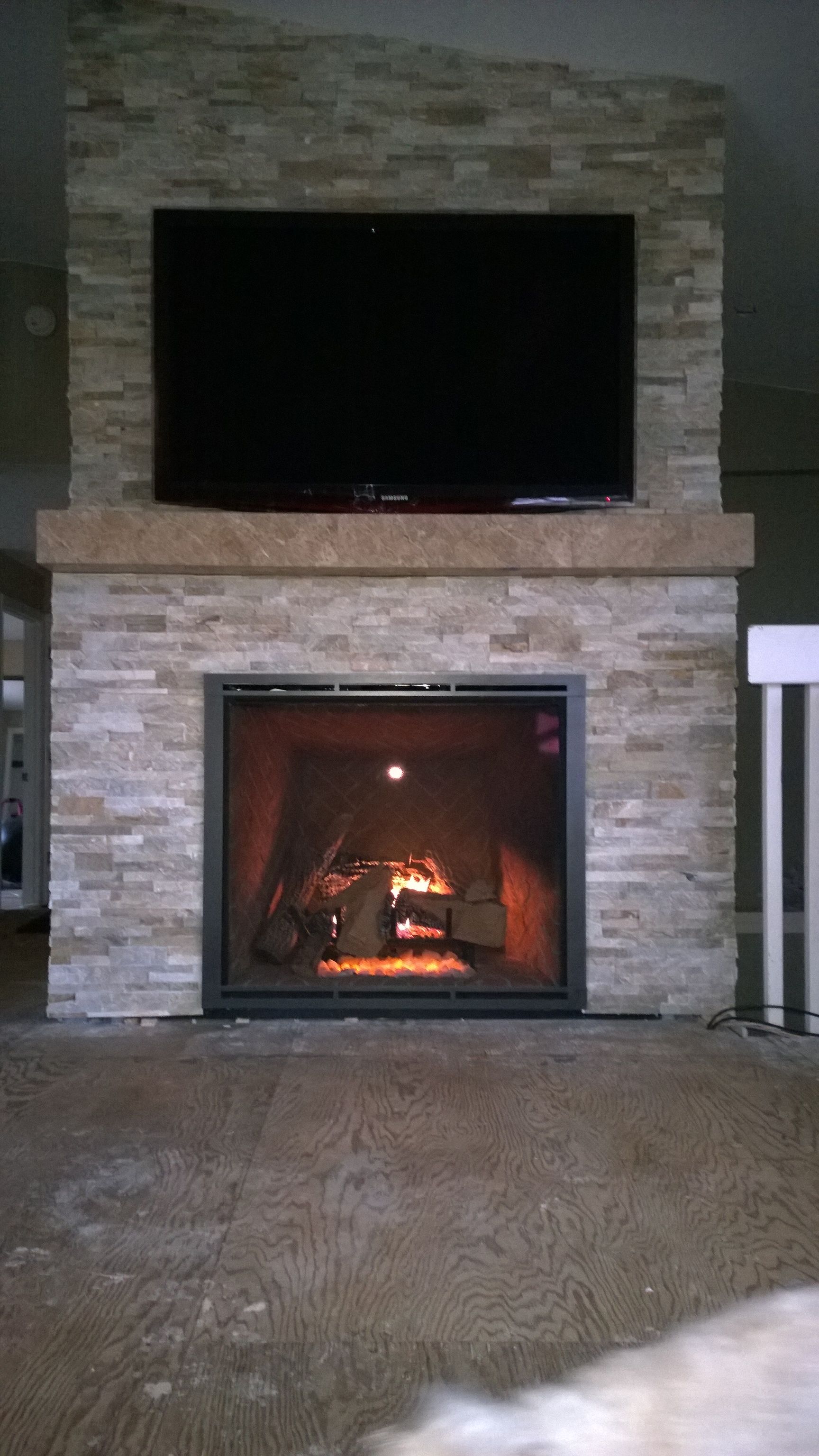 A fireplace with a flat screen tv above it in a living room.
