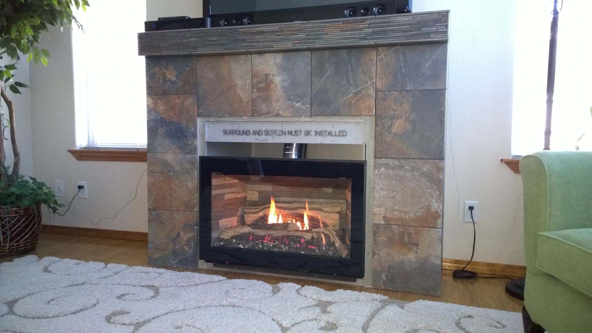 A living room with a fireplace and a television.