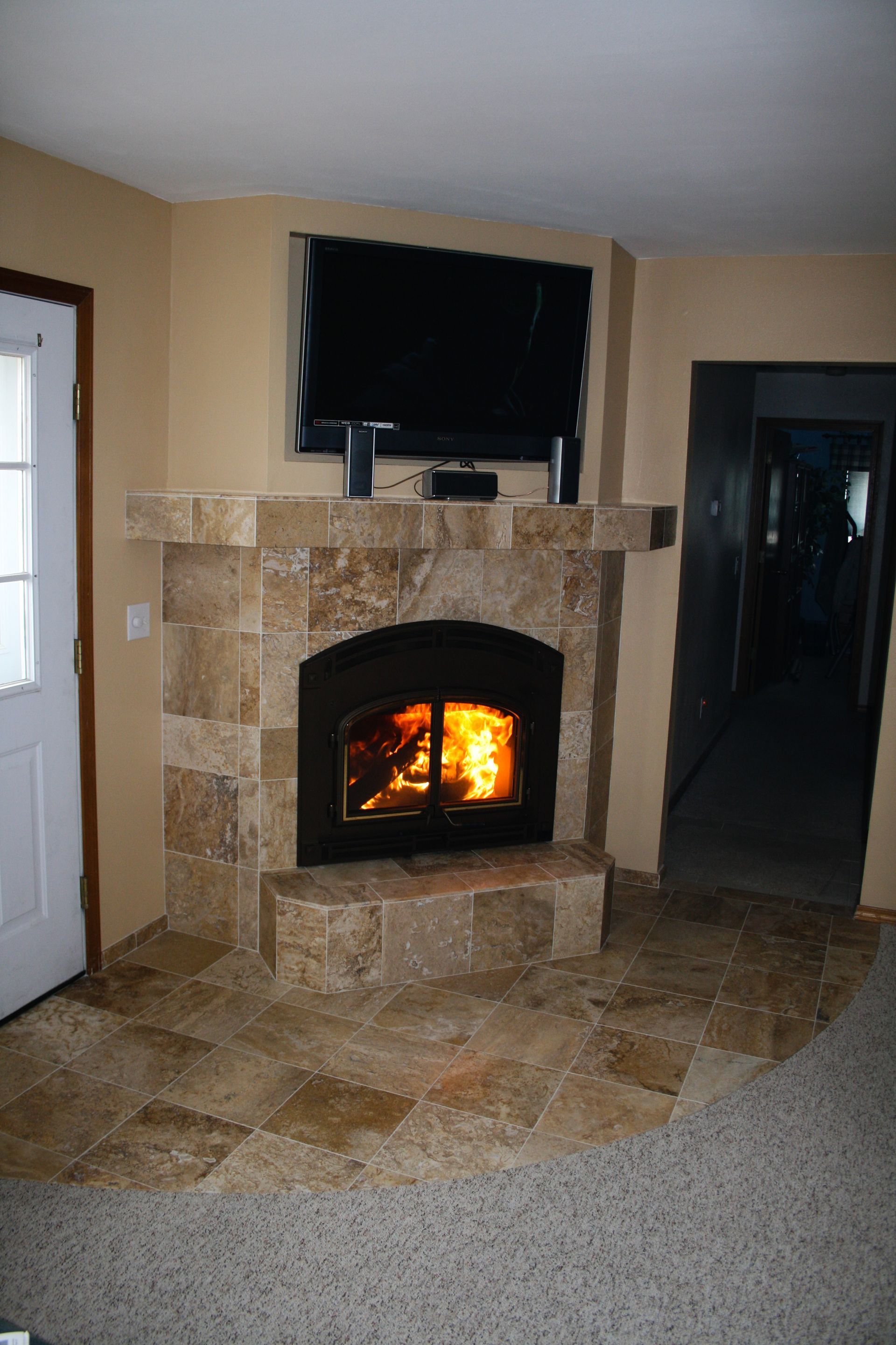 A living room with a fireplace and a flat screen tv