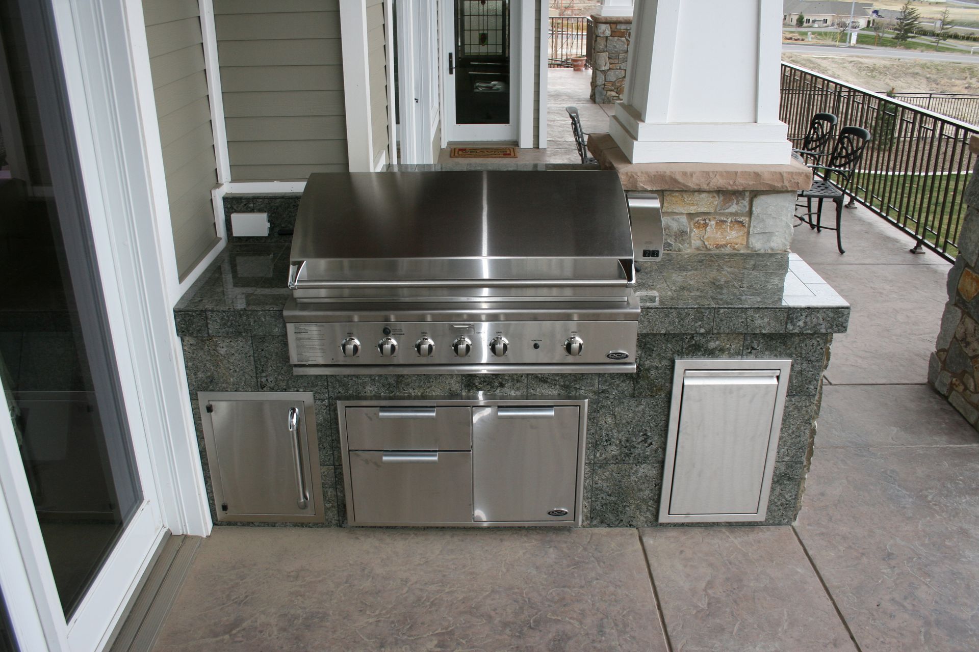 A stainless steel grill is sitting on a granite counter top