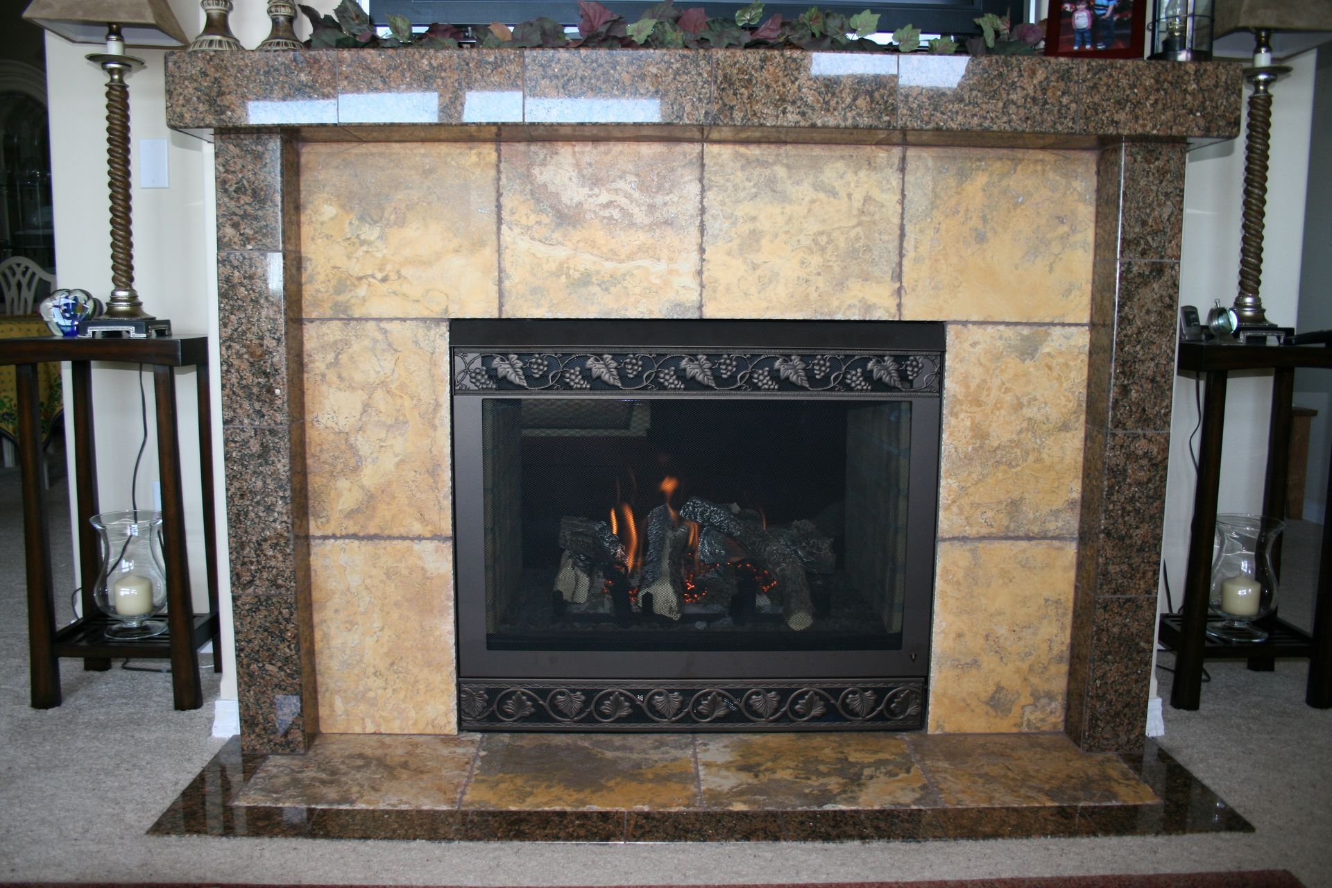 A fireplace in a living room with a marble mantle