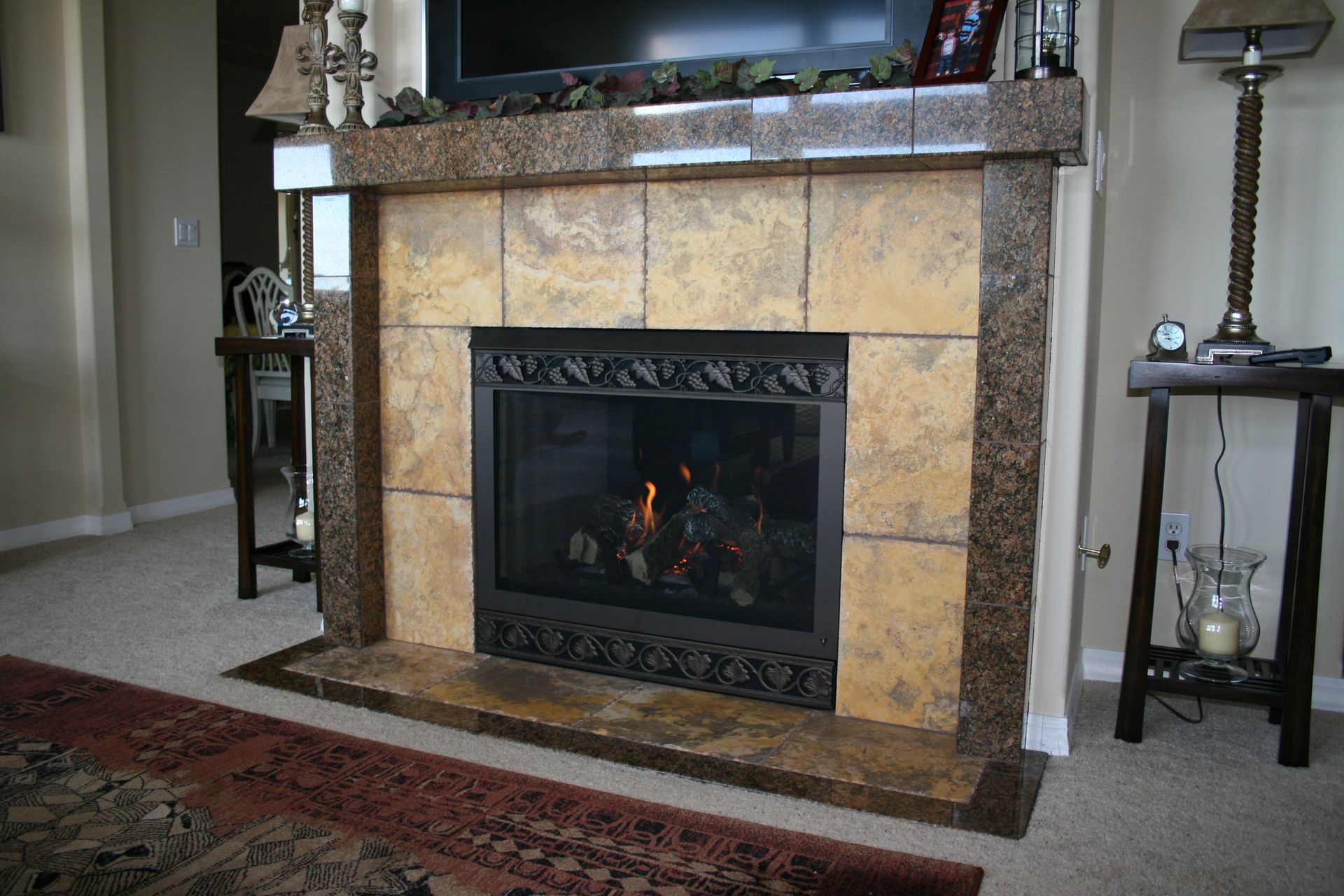 A living room with a fireplace and a flat screen tv
