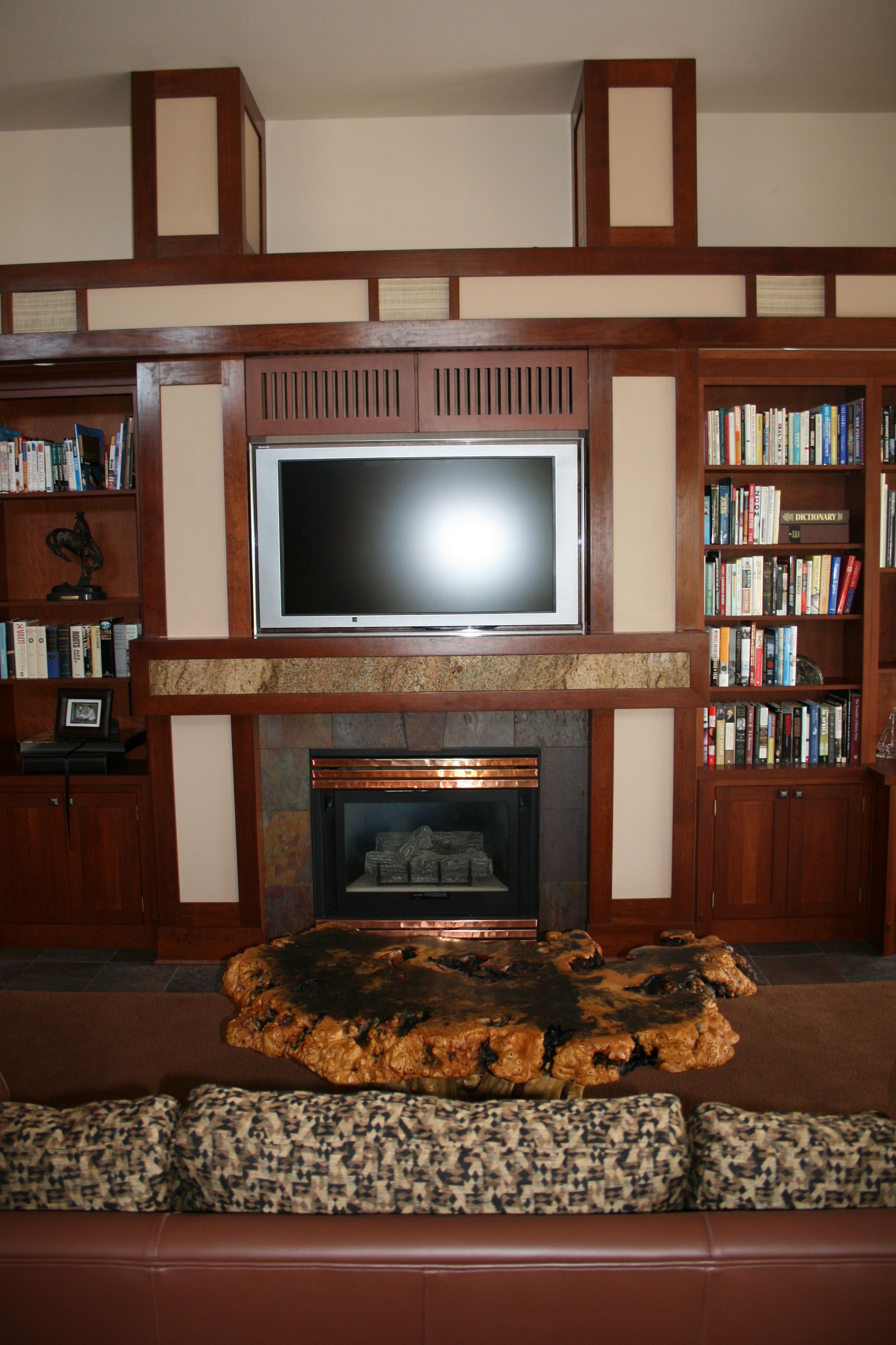 A living room with a fireplace and a flat screen tv