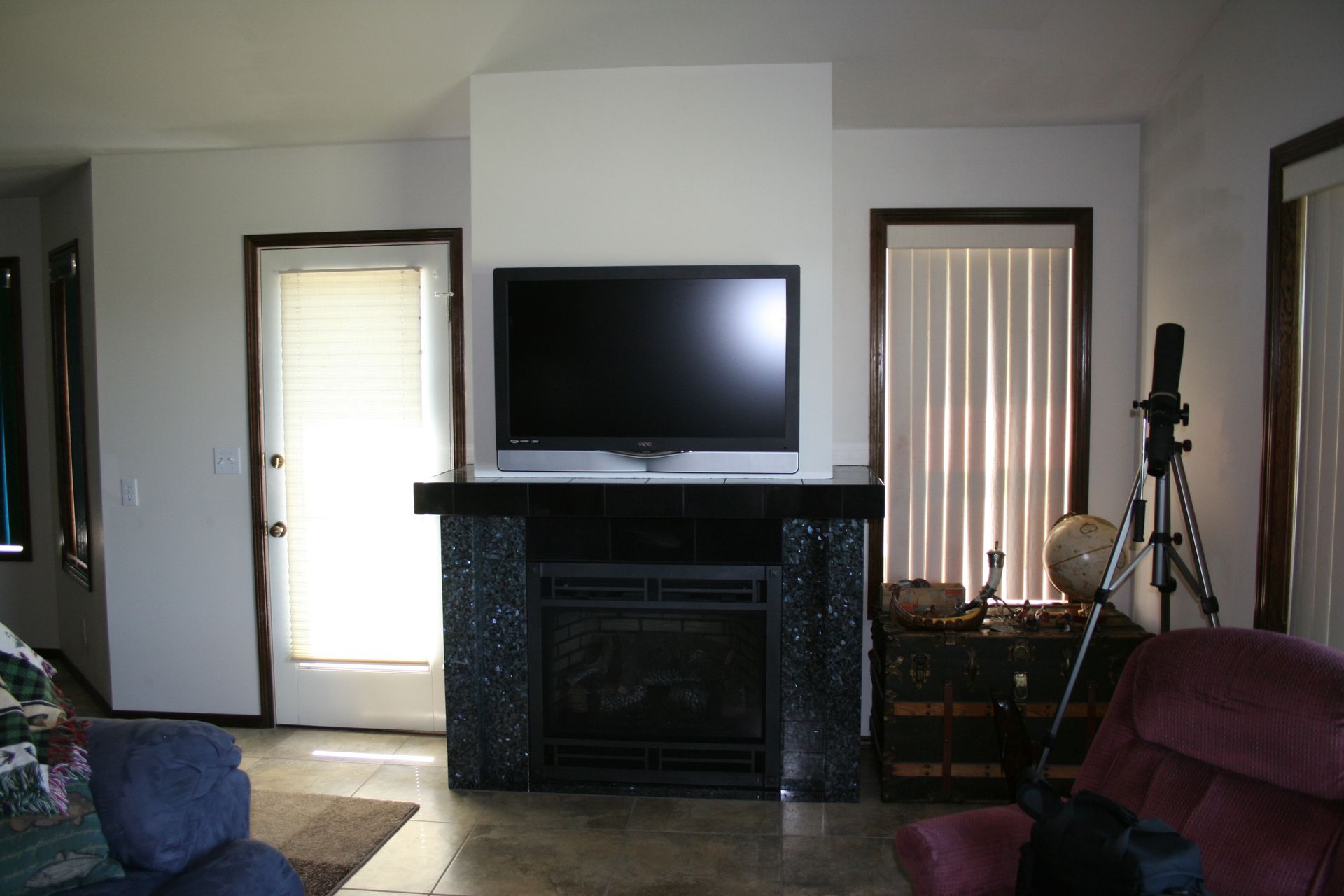 A living room with a fireplace and a flat screen tv