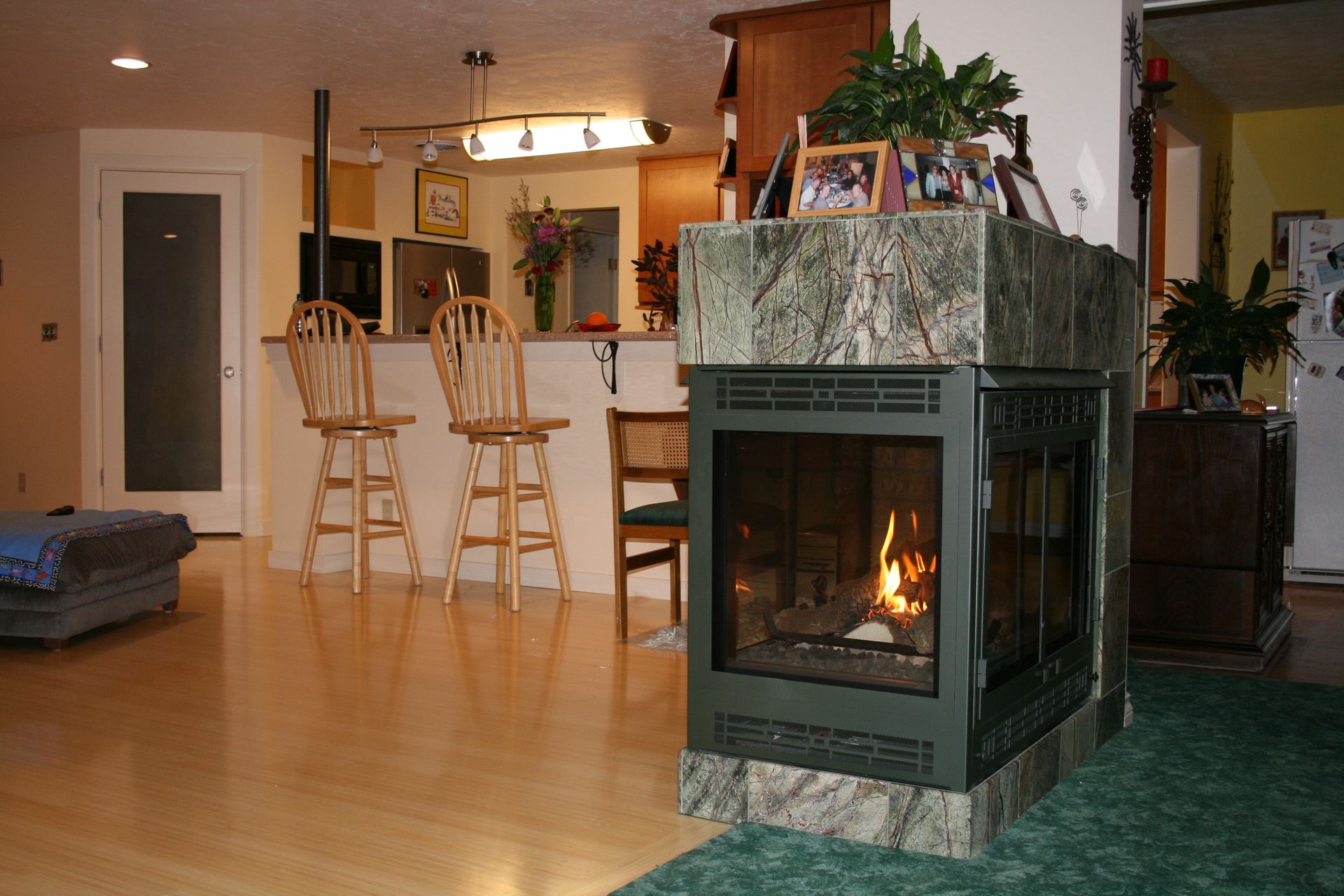 A living room with a fireplace in the middle