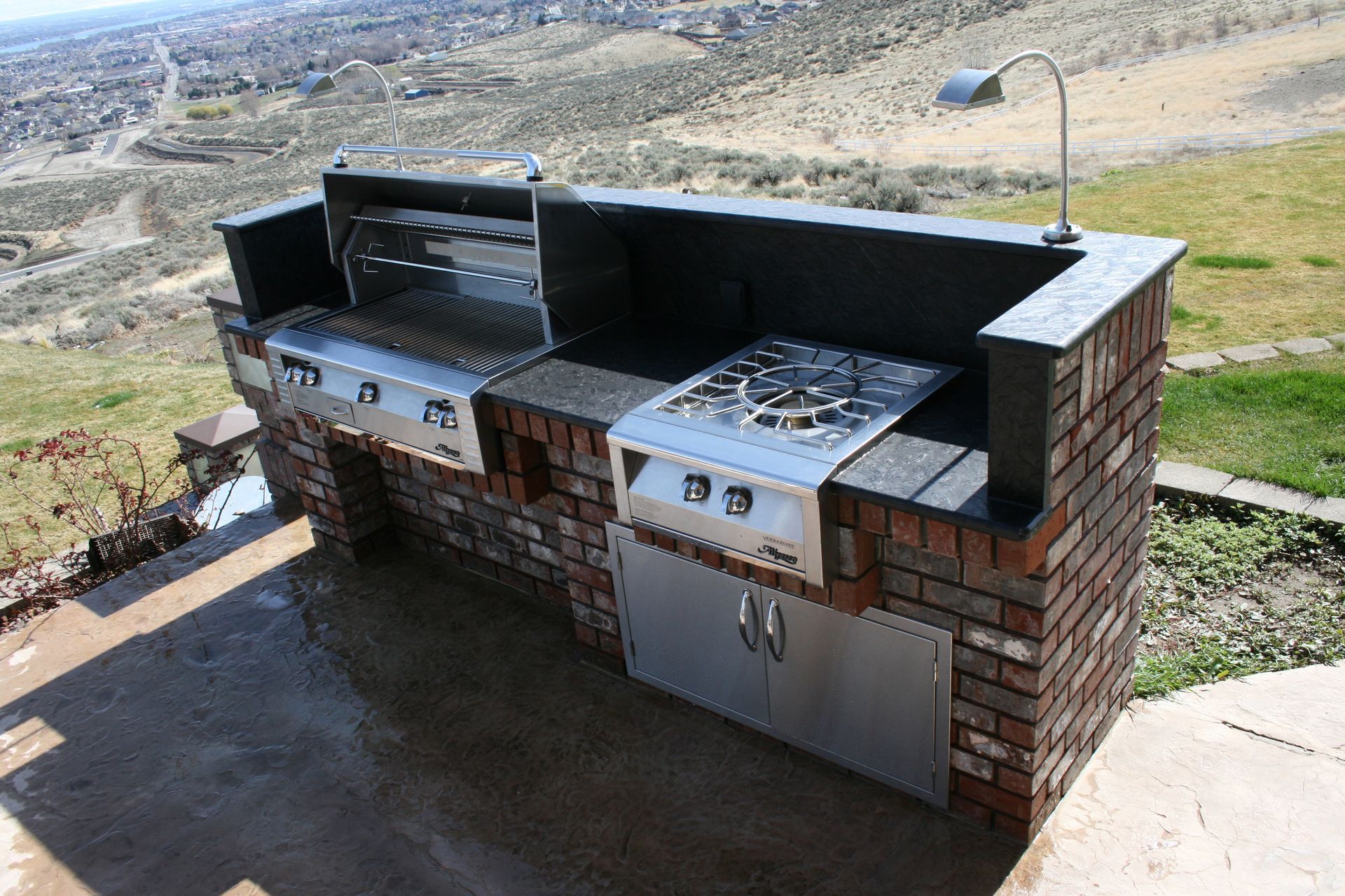 A large outdoor kitchen with a view of a city.