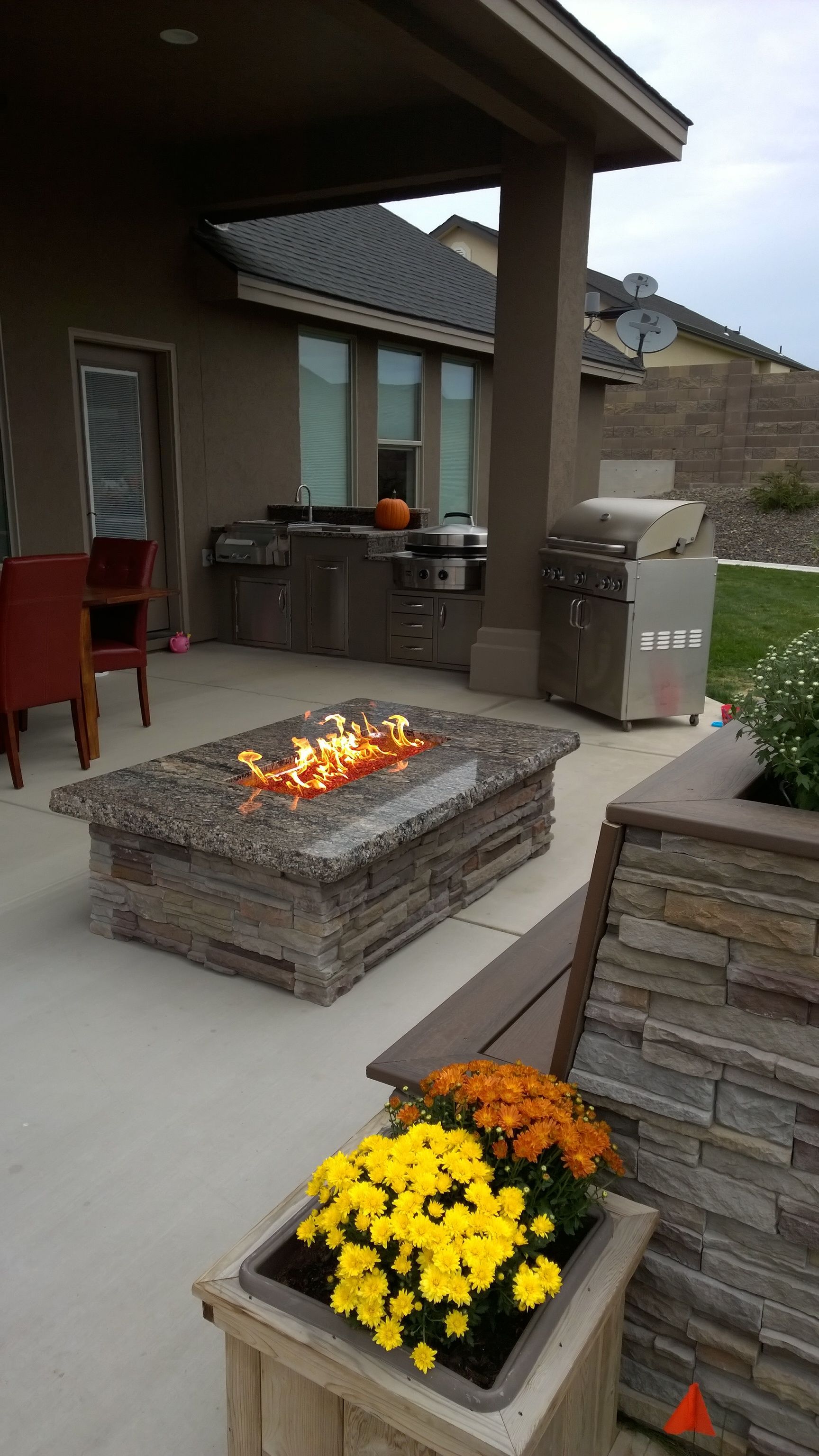 There is a fire pit in the middle of the patio.