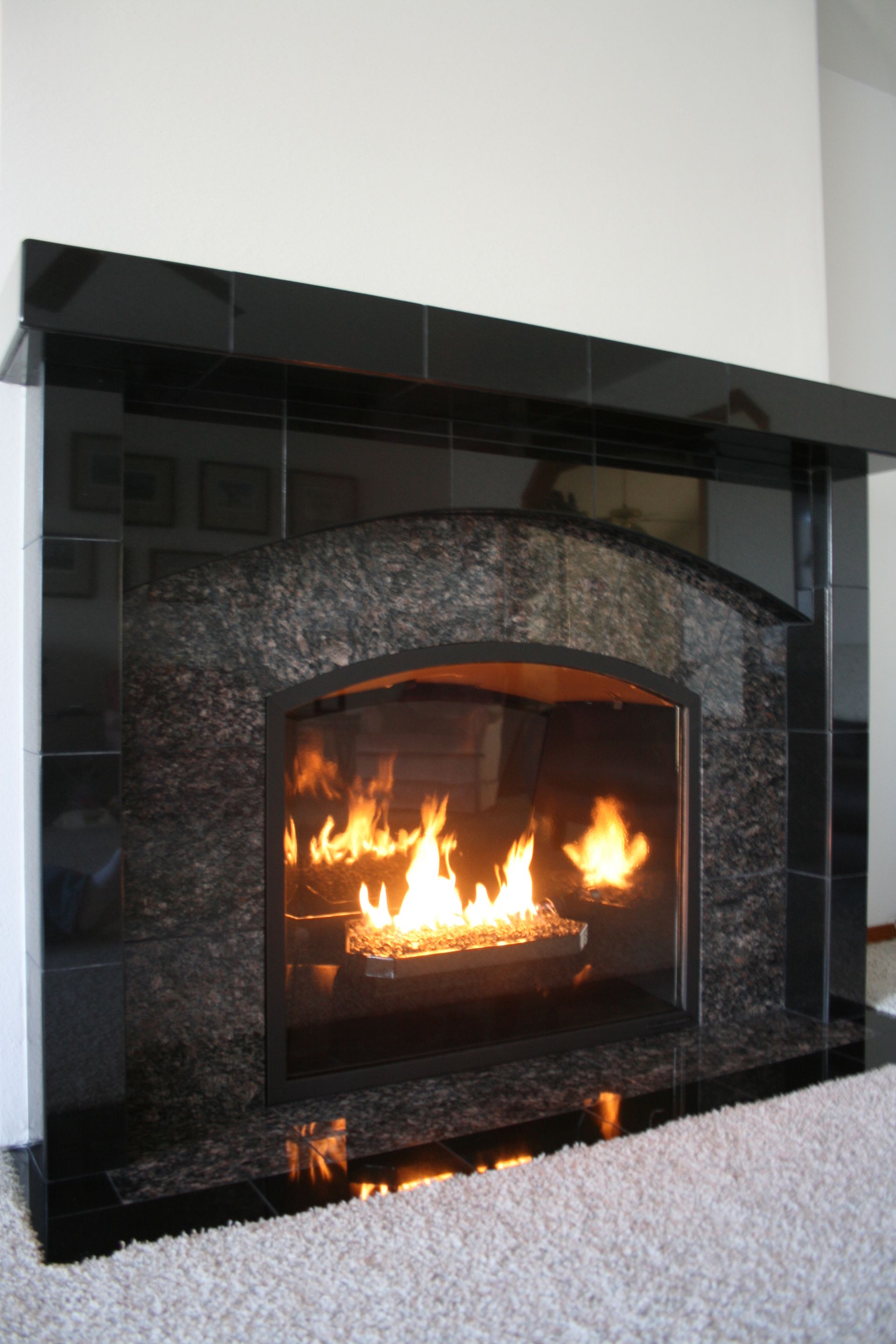 A fireplace with flames coming out of it in a living room