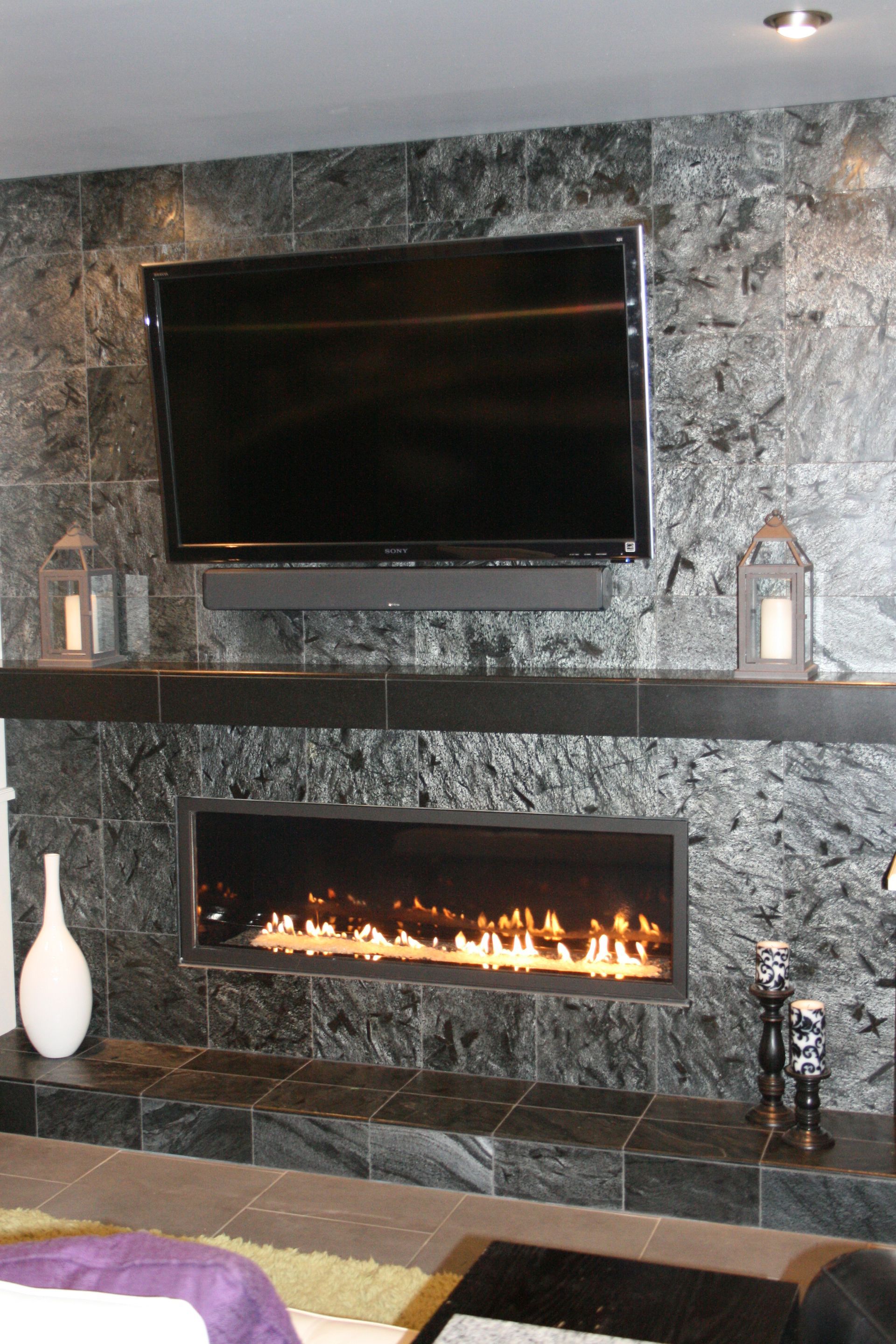 A living room with a fireplace and a flat screen tv