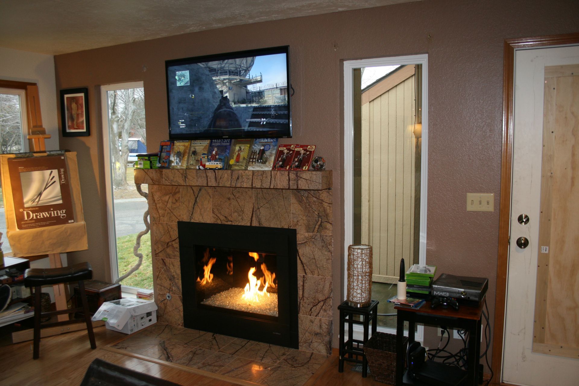 A living room with a fireplace and a flat screen tv