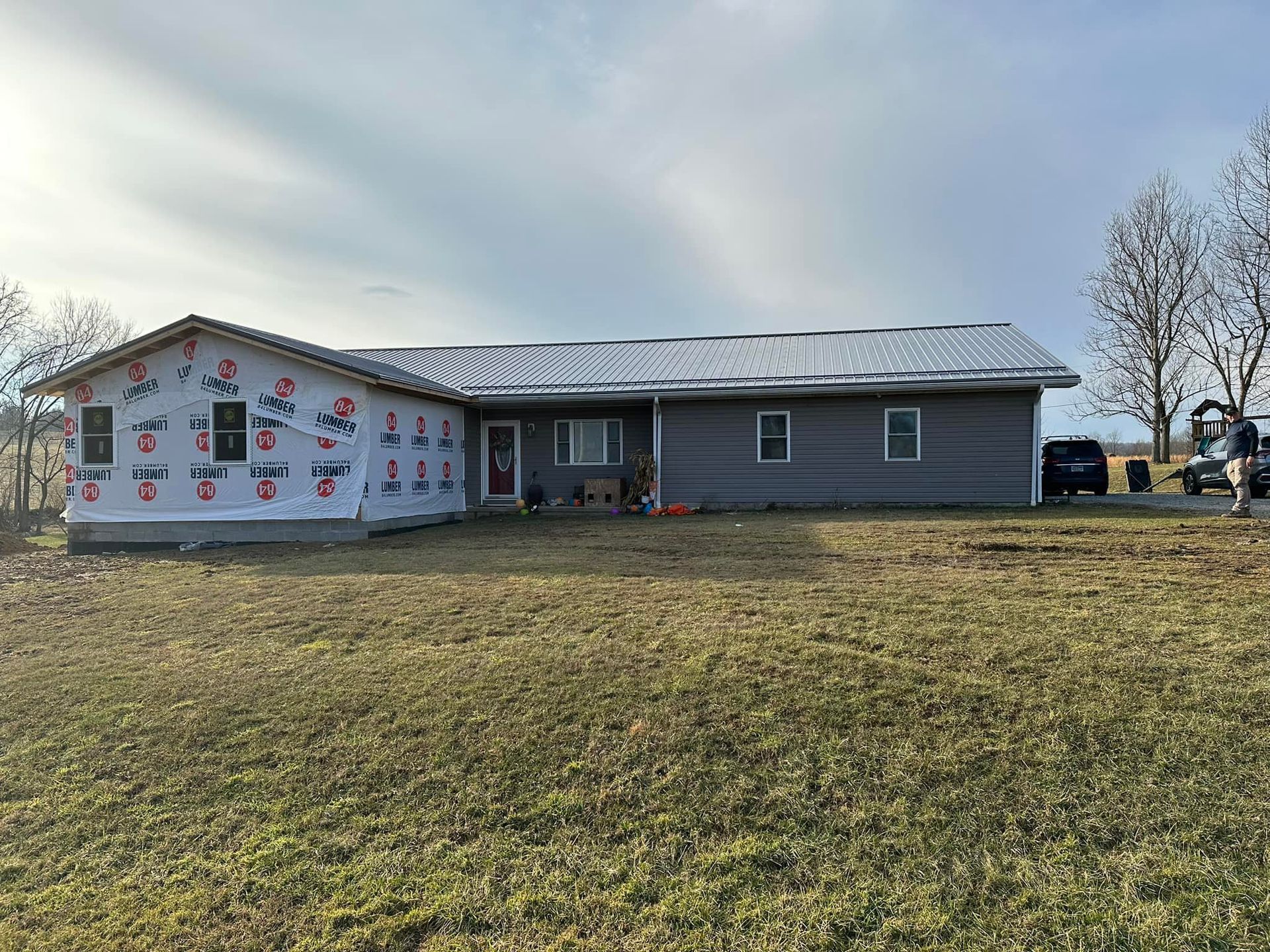 A house is being built in the middle of a grassy field.