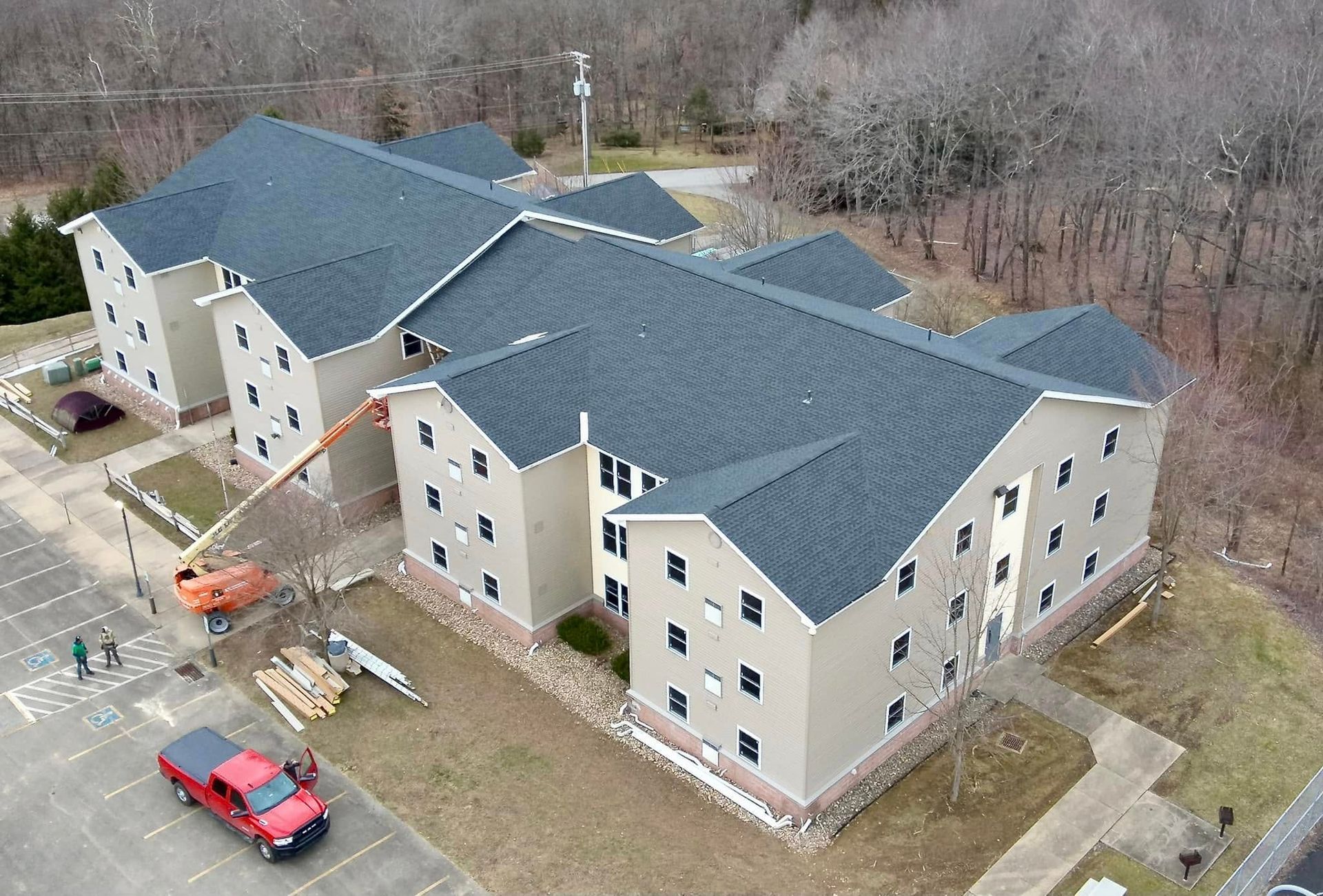 An aerial view of a large building with a blue roof