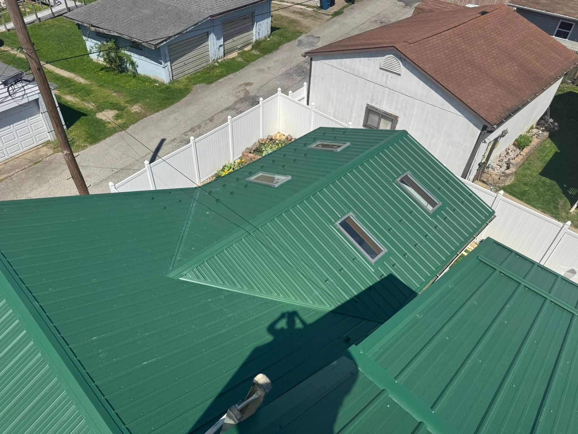 An aerial view of a house with a green roof.