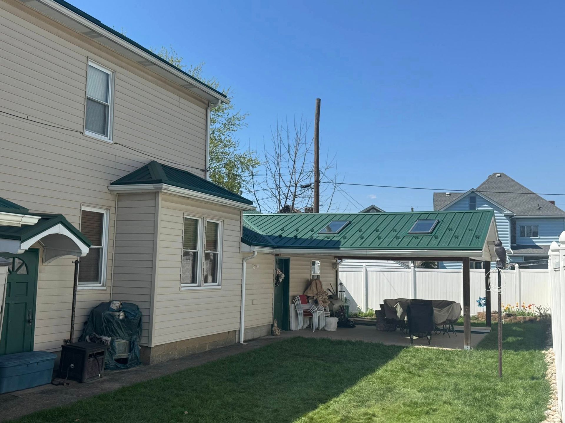 The backyard of a house with a green roof