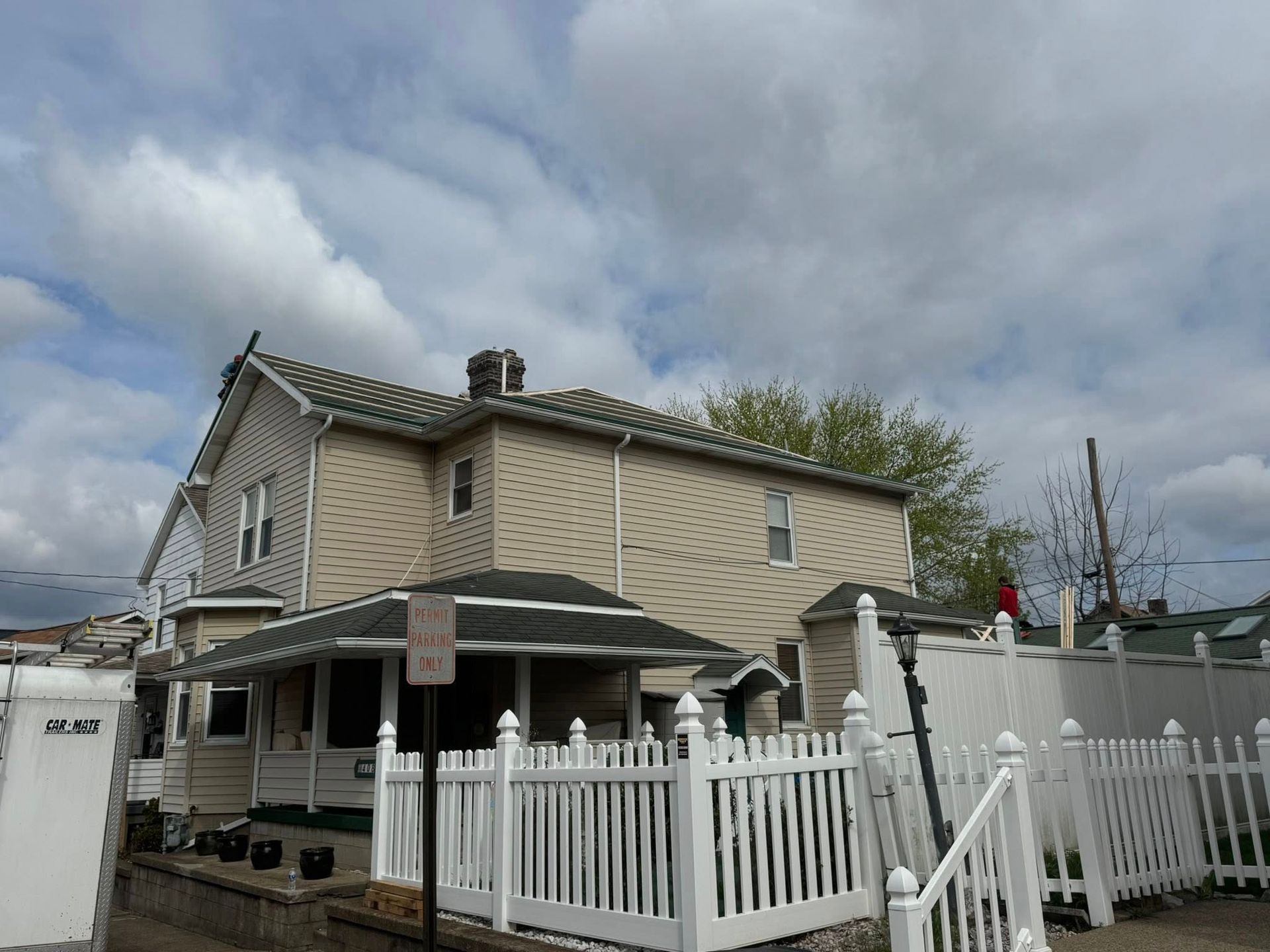 A house with a white picket fence in front of it