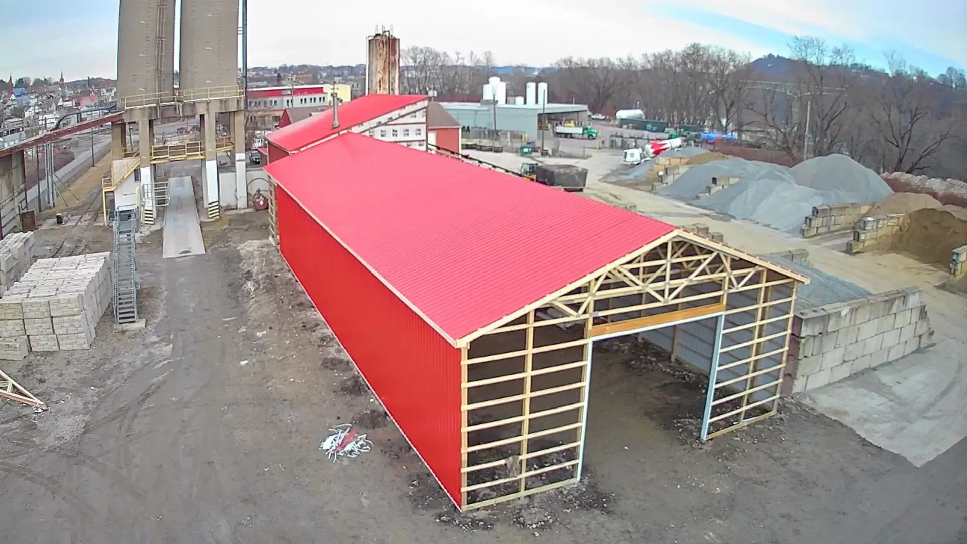 An aerial view of a building under construction with a red roof