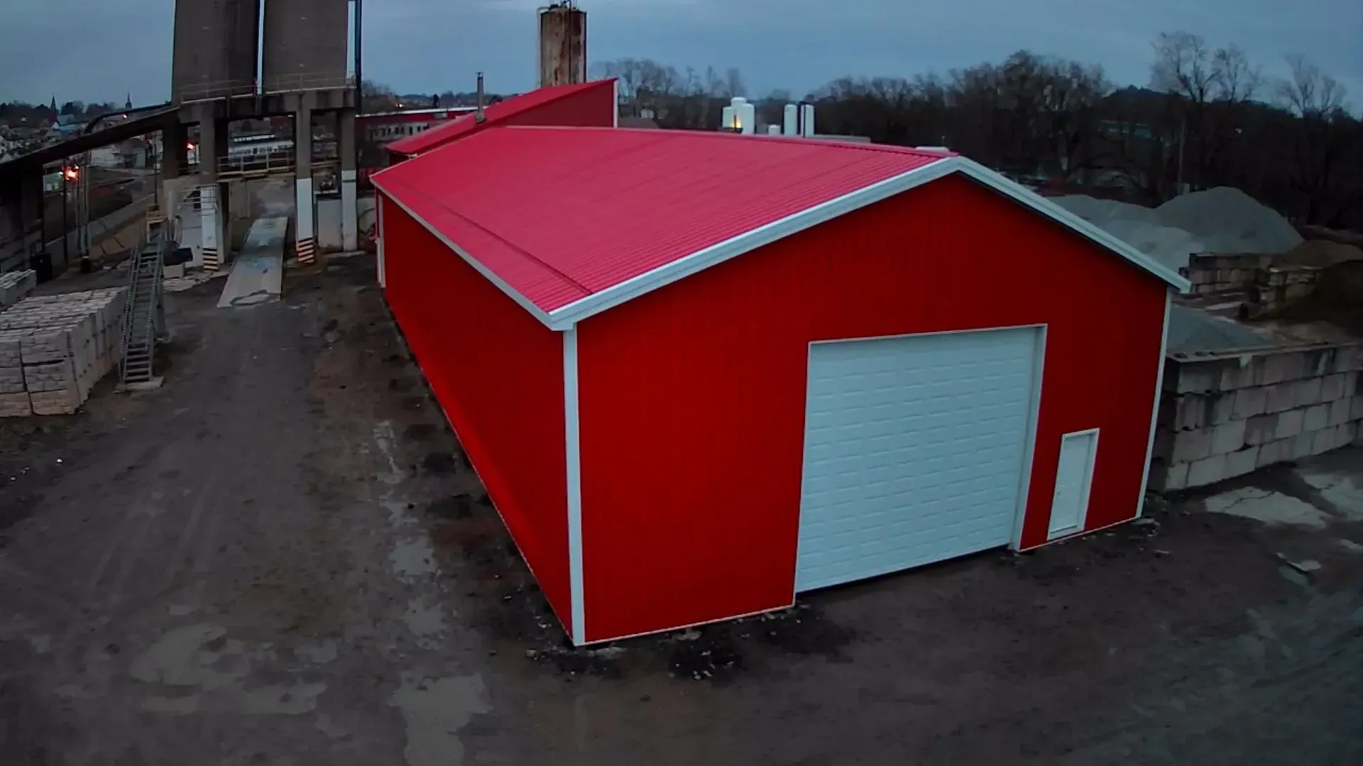 A red barn with a white trim and a red roof