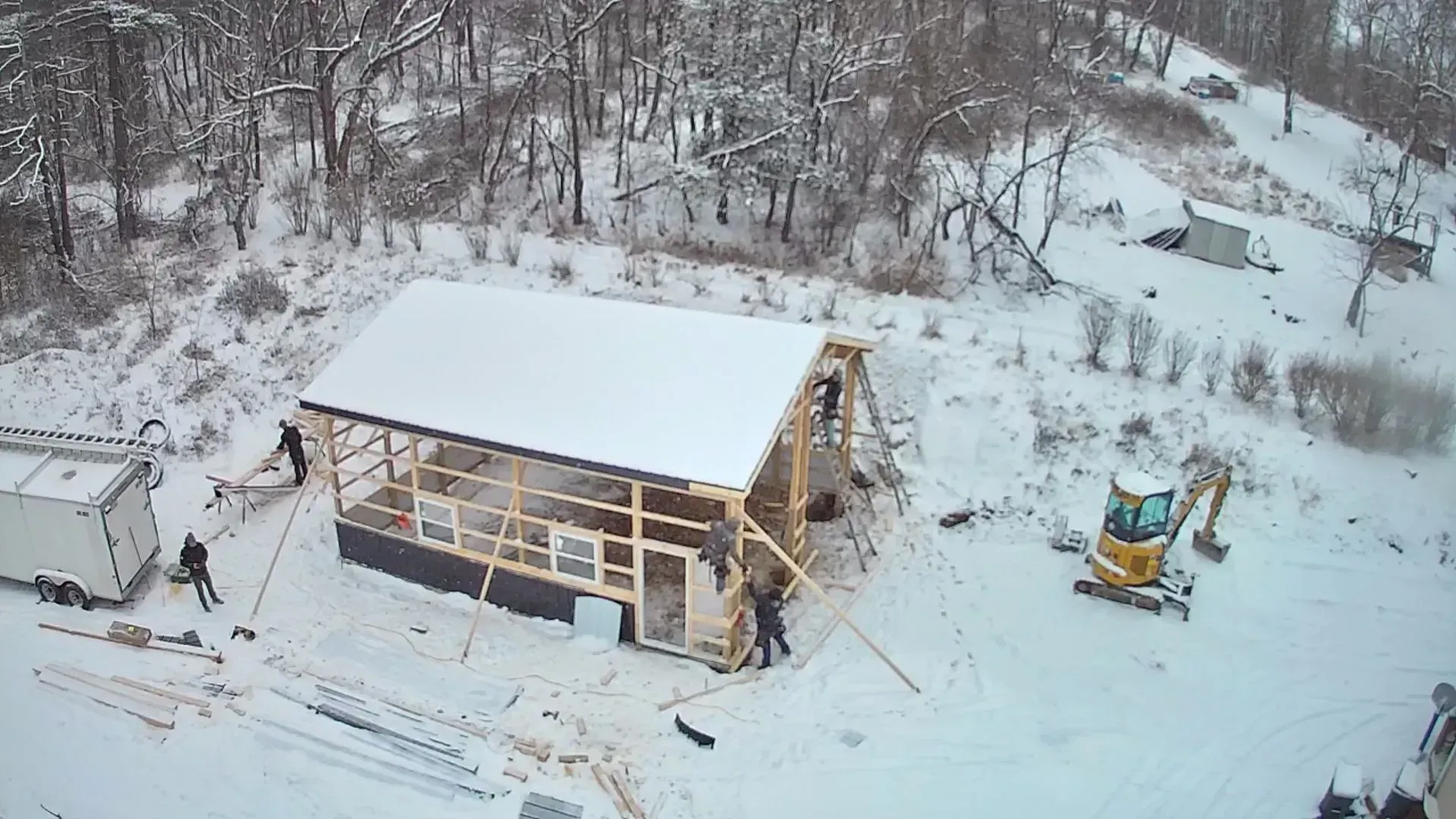 An aerial view of a building under construction in the snow.
