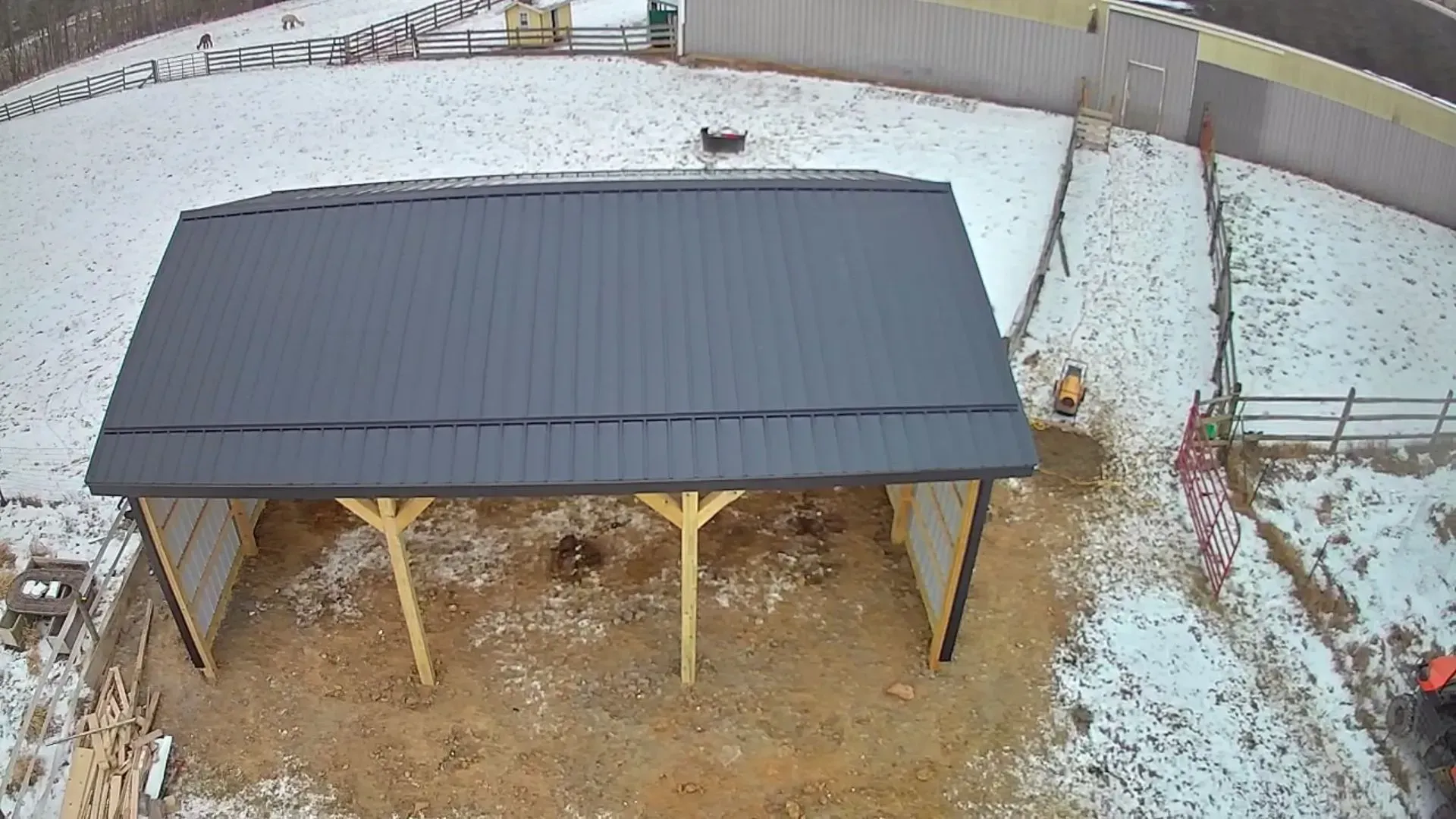 An aerial view of a building under construction in the snow.